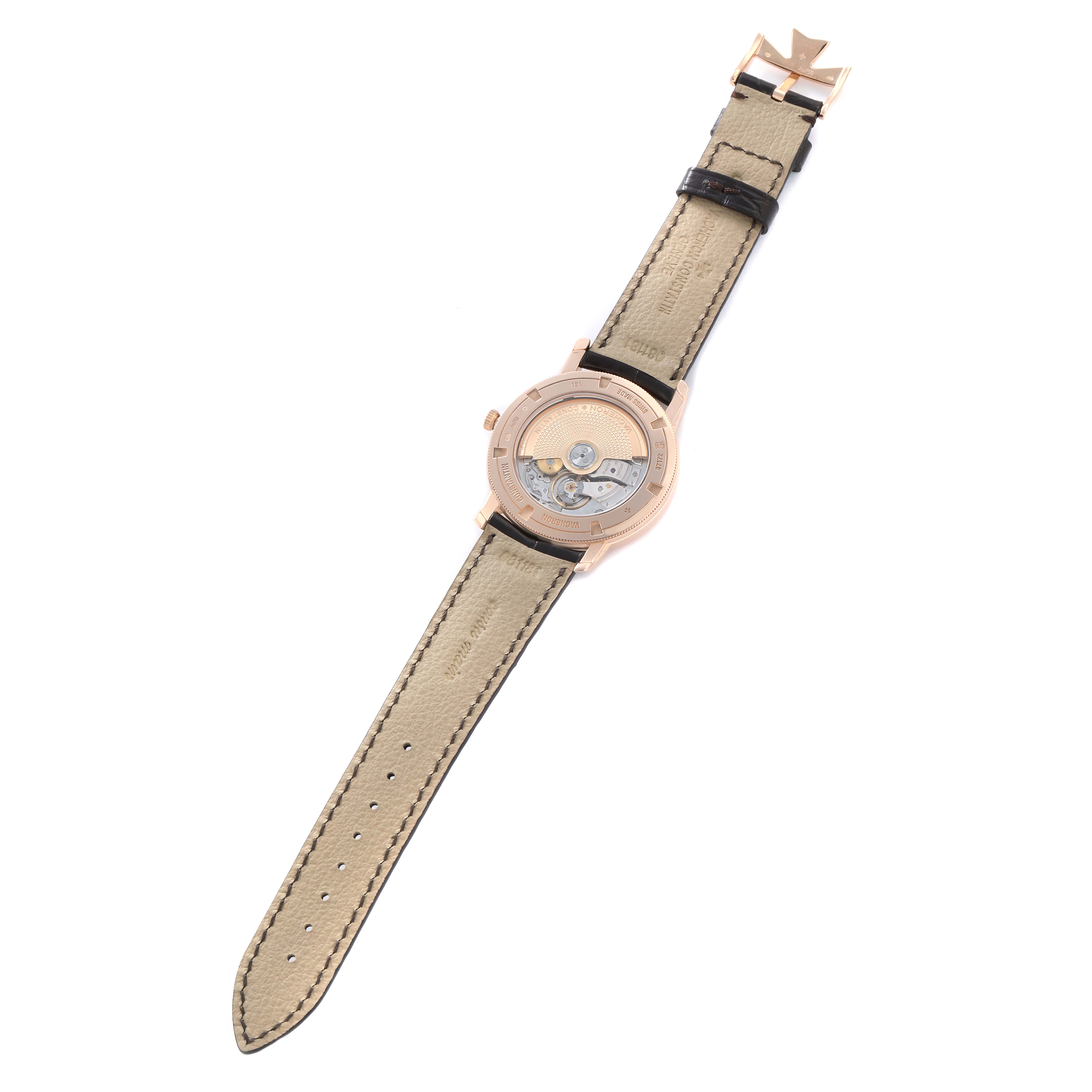 The Vacheron Constantin Traditionnelle 87172 Men
s Rose Gold Silver Dial watch is shown from the back, displaying the intricate movement and the leather strap.