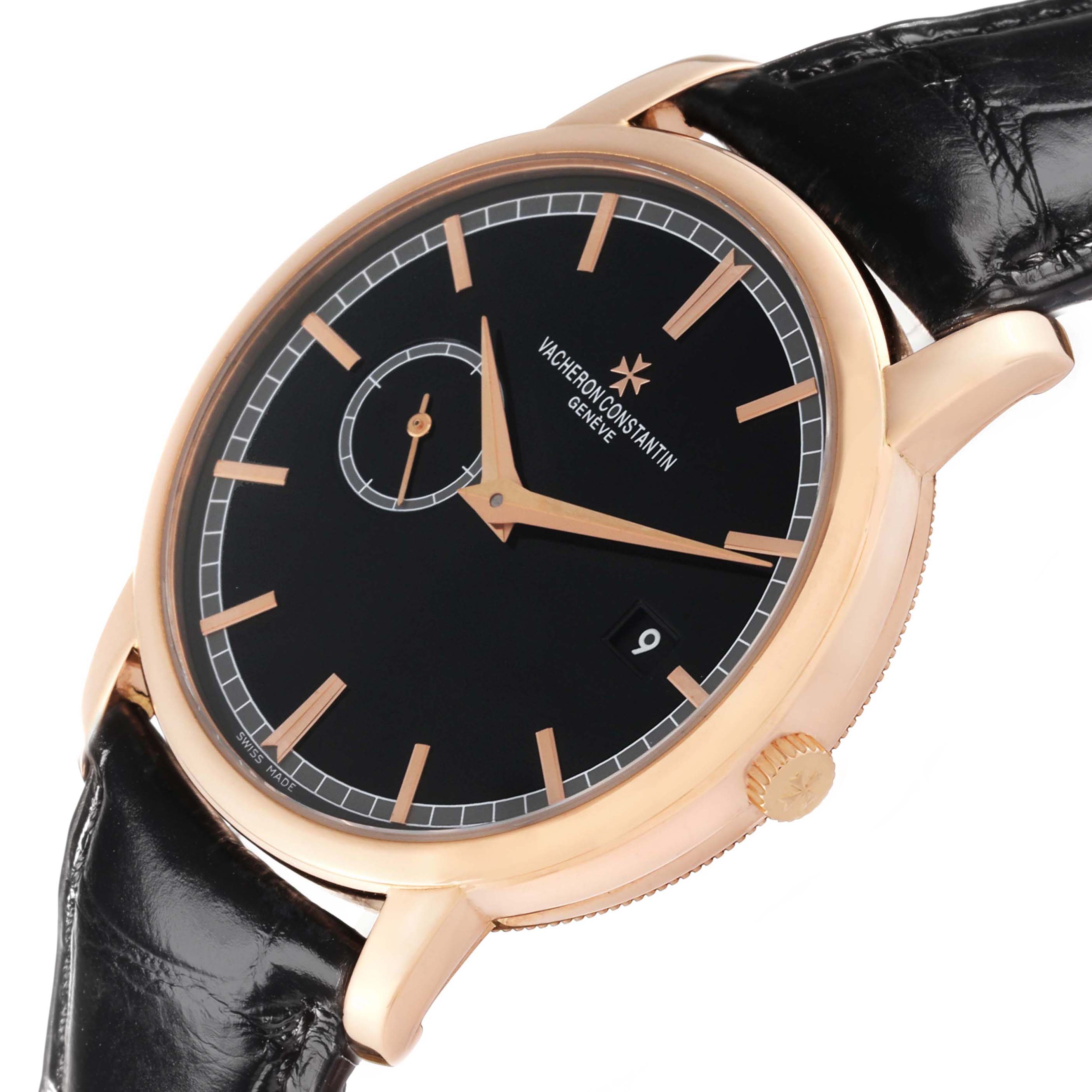 The Vacheron Constantin Traditionnelle 87172 Men
s Rose Gold Black Dial watch is shown at an angled side view, highlighting the dial, crown, and black strap.