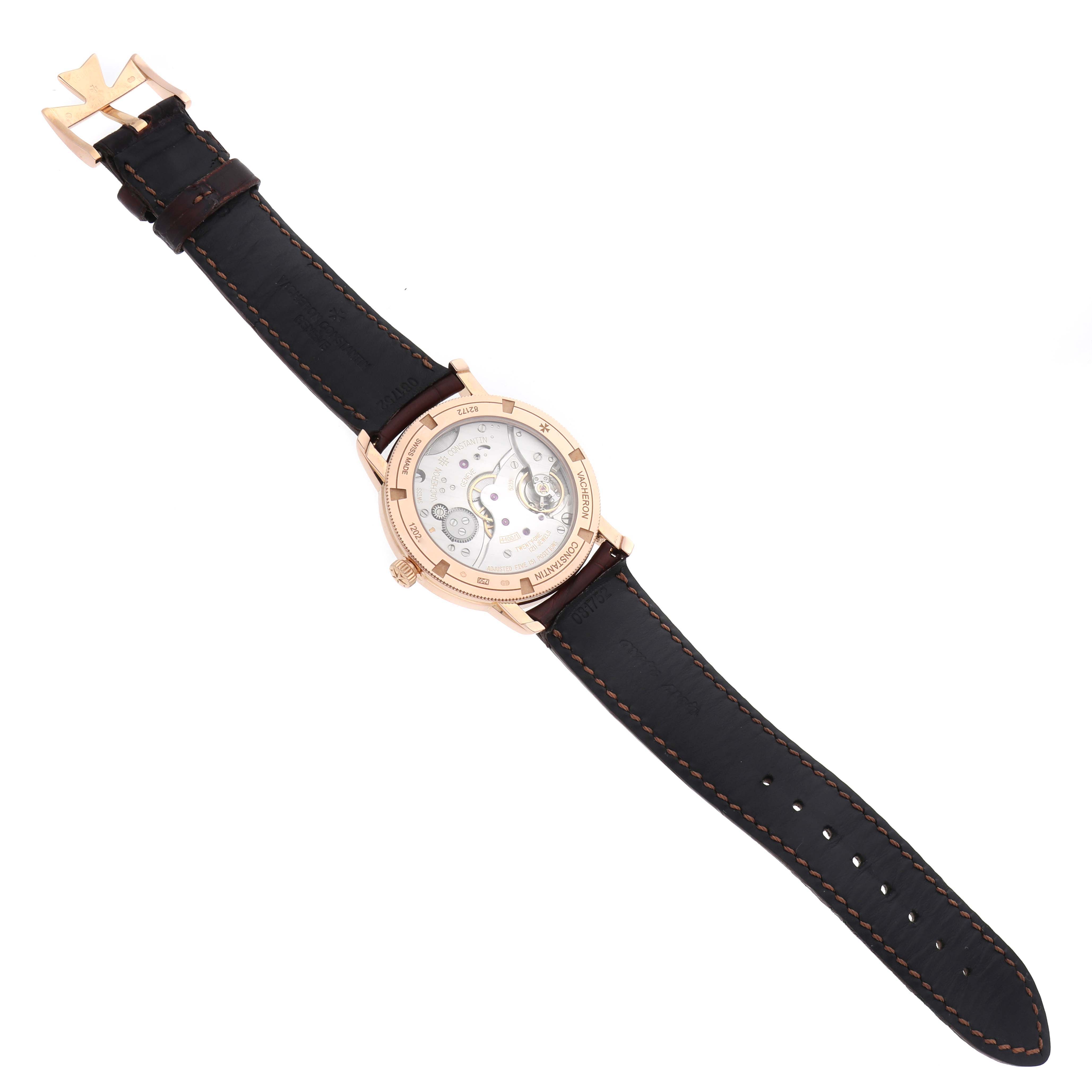 The watch is angled to show the back of the case and movement of the Vacheron Constantin Traditionnelle 82172 Men
s Rose Gold Silver Dial, with the leather strap visible.