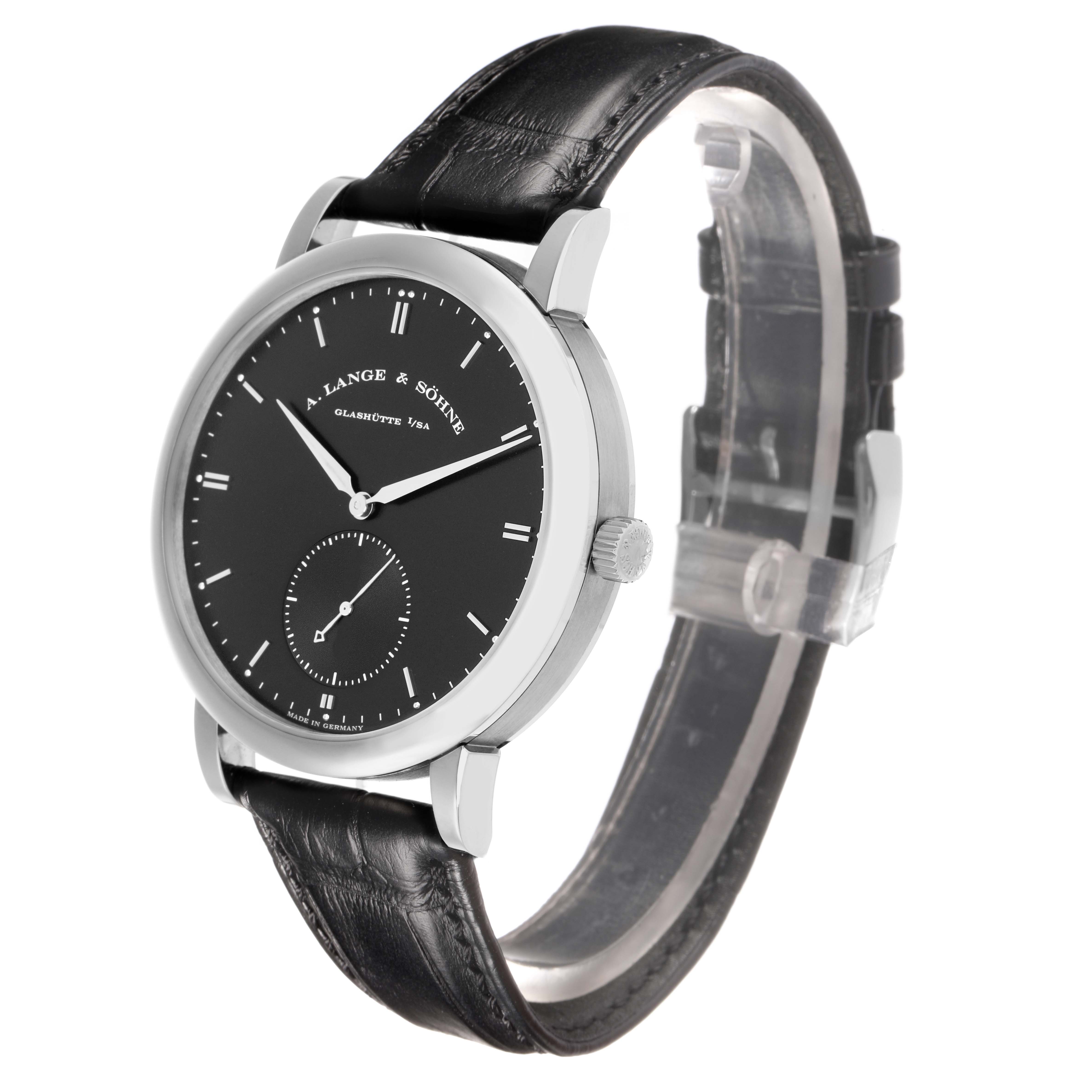 The A. Lange 
Sohne Saxonia 307.029 Men
s White Gold Black Dial watch is shown at a three-quarter angle, highlighting its black dial, silver case, and leather strap.