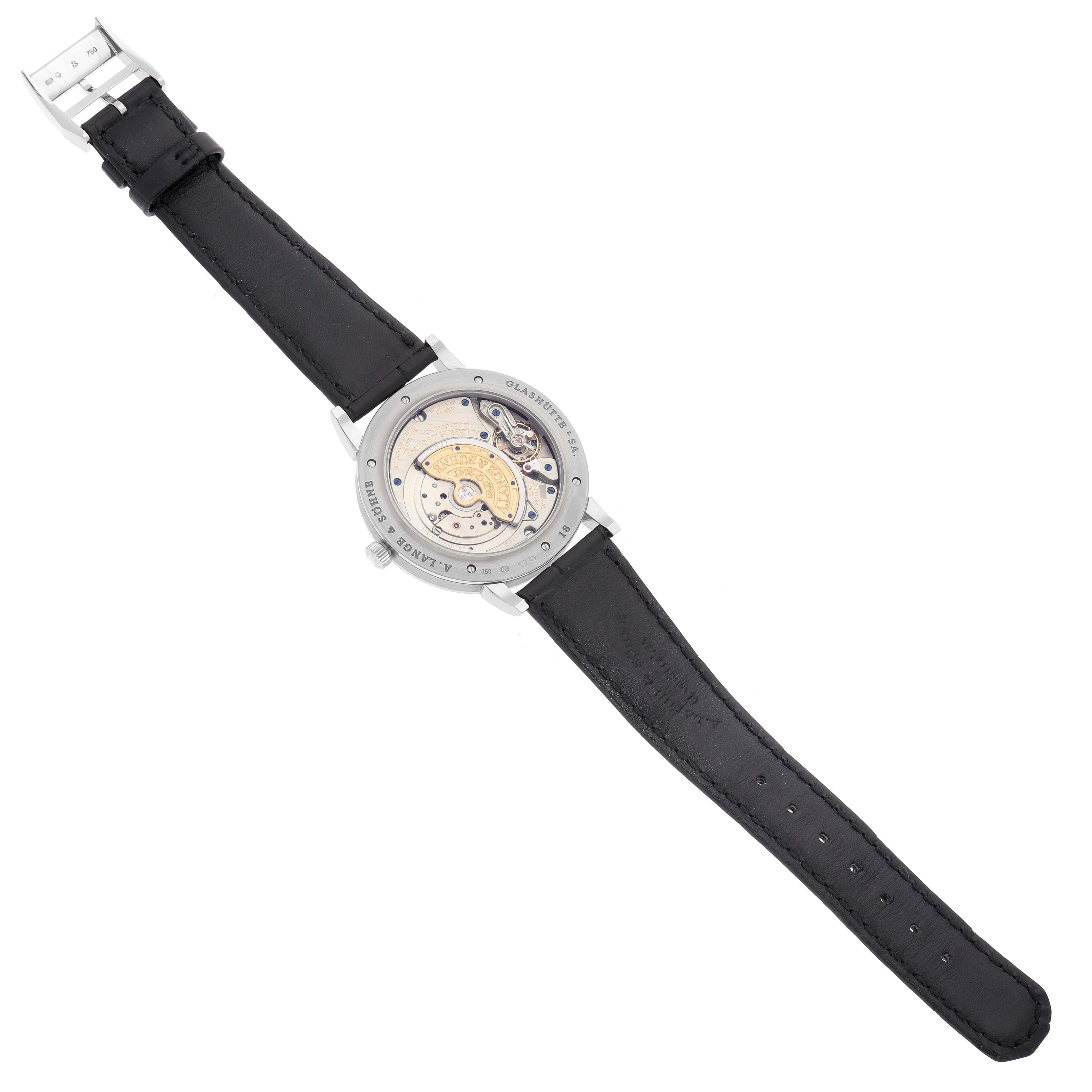 The image shows the back view of the A. Lange 
Sohne Saxonia 307.029 Men
s White Gold Black Dial watch, highlighting its movement and leather strap.