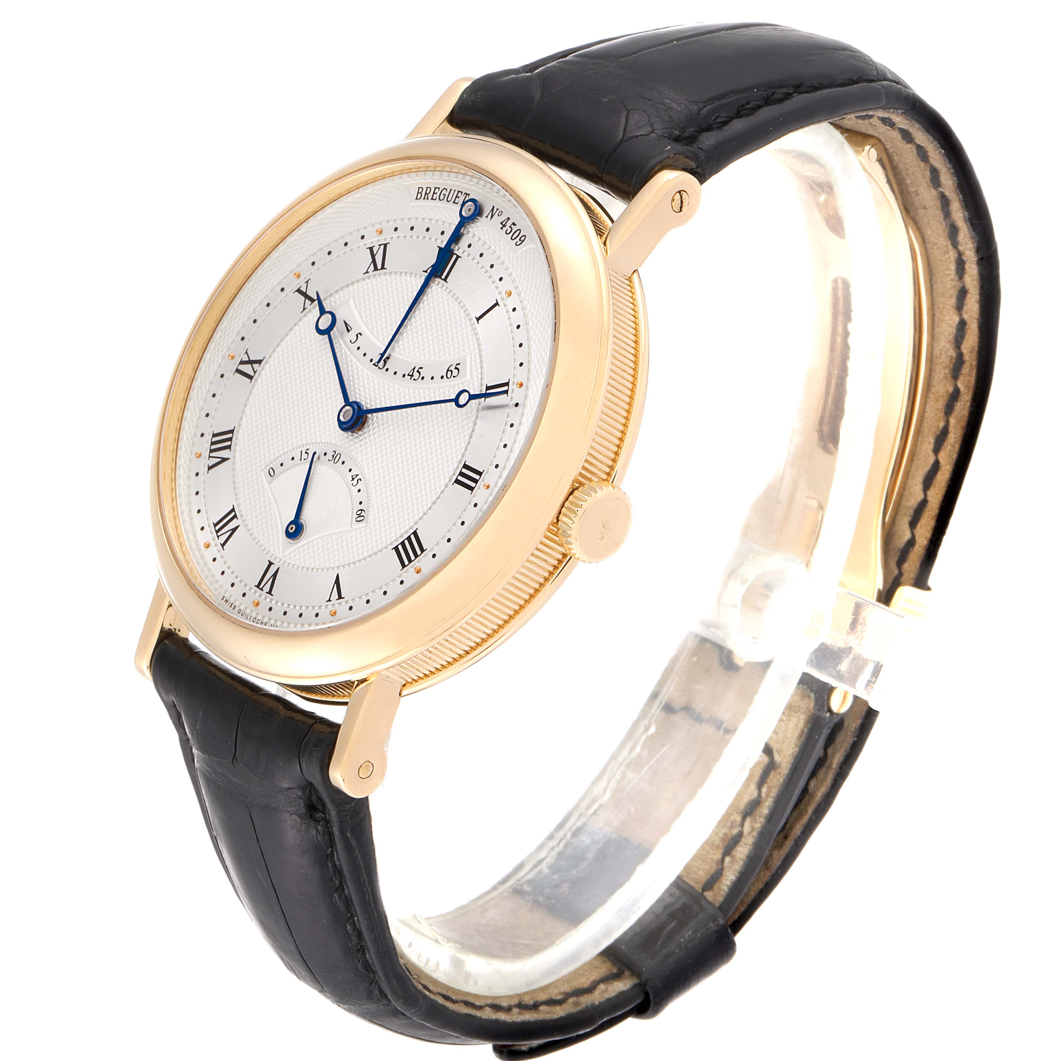 The Breguet Classique 5207BA/12/9V6 Men's Yellow Gold Silver Dial 5207BA/12/9V6 Men's Yellow Gold Silver Dial watch is shown at a slight angle showcasing the dial, hands, crown, and leather strap.