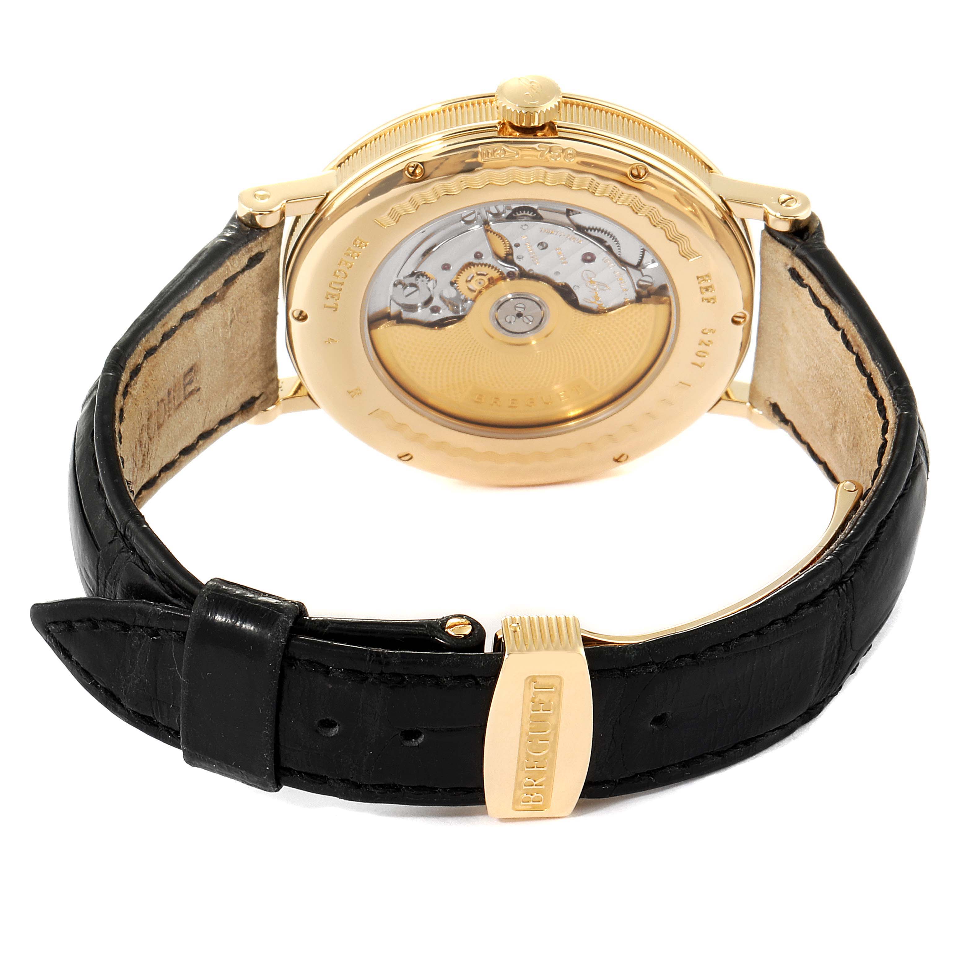 This image shows the back view of a Breguet Classique 5207BA/12/9V6 Men's Yellow Gold Silver Dial 5207BA/12/9V6 Men's Yellow Gold Silver Dial watch, highlighting its transparent case back and black leather strap.