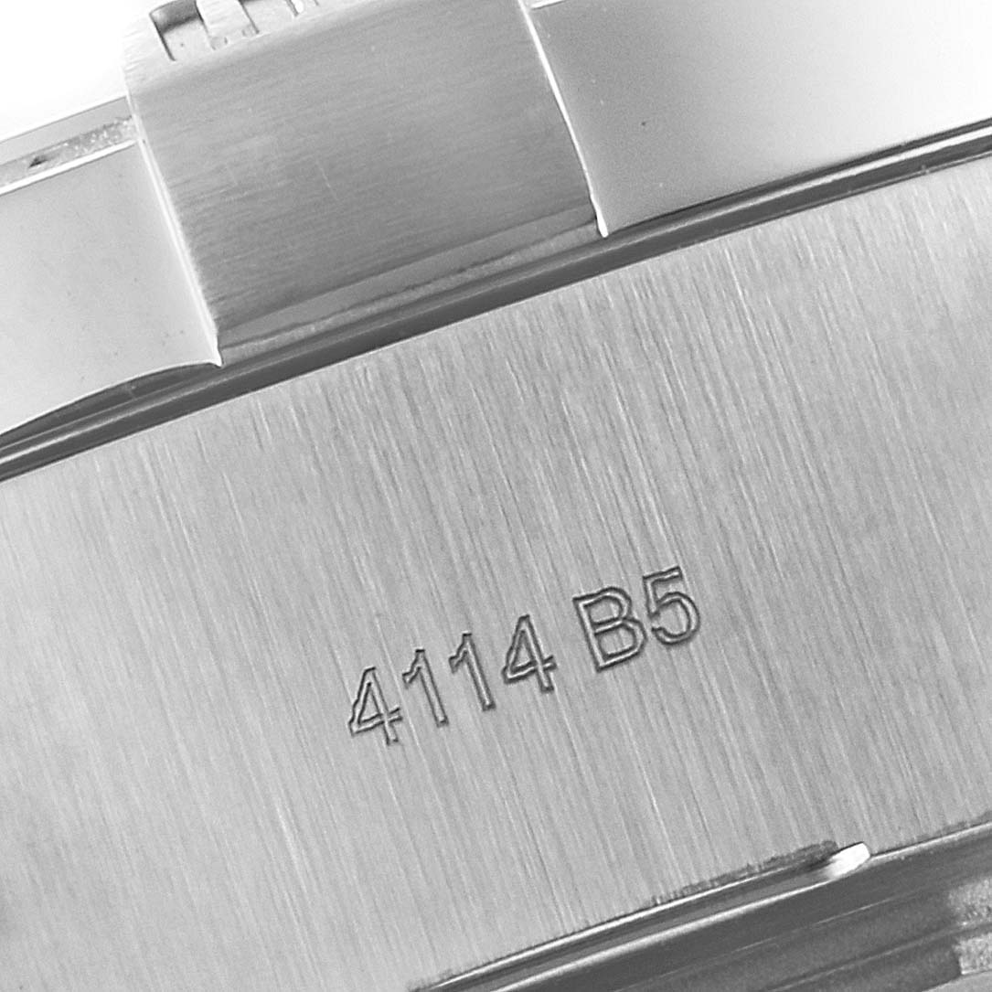 The image shows a close-up view of the case back of a Breitling Avenger A17331 Men's Stainless Steel Yellow Dial A17331 Men's Stainless Steel Yellow Dial watch, with part of the bracelet and an engraved reference number, 4114 B5.