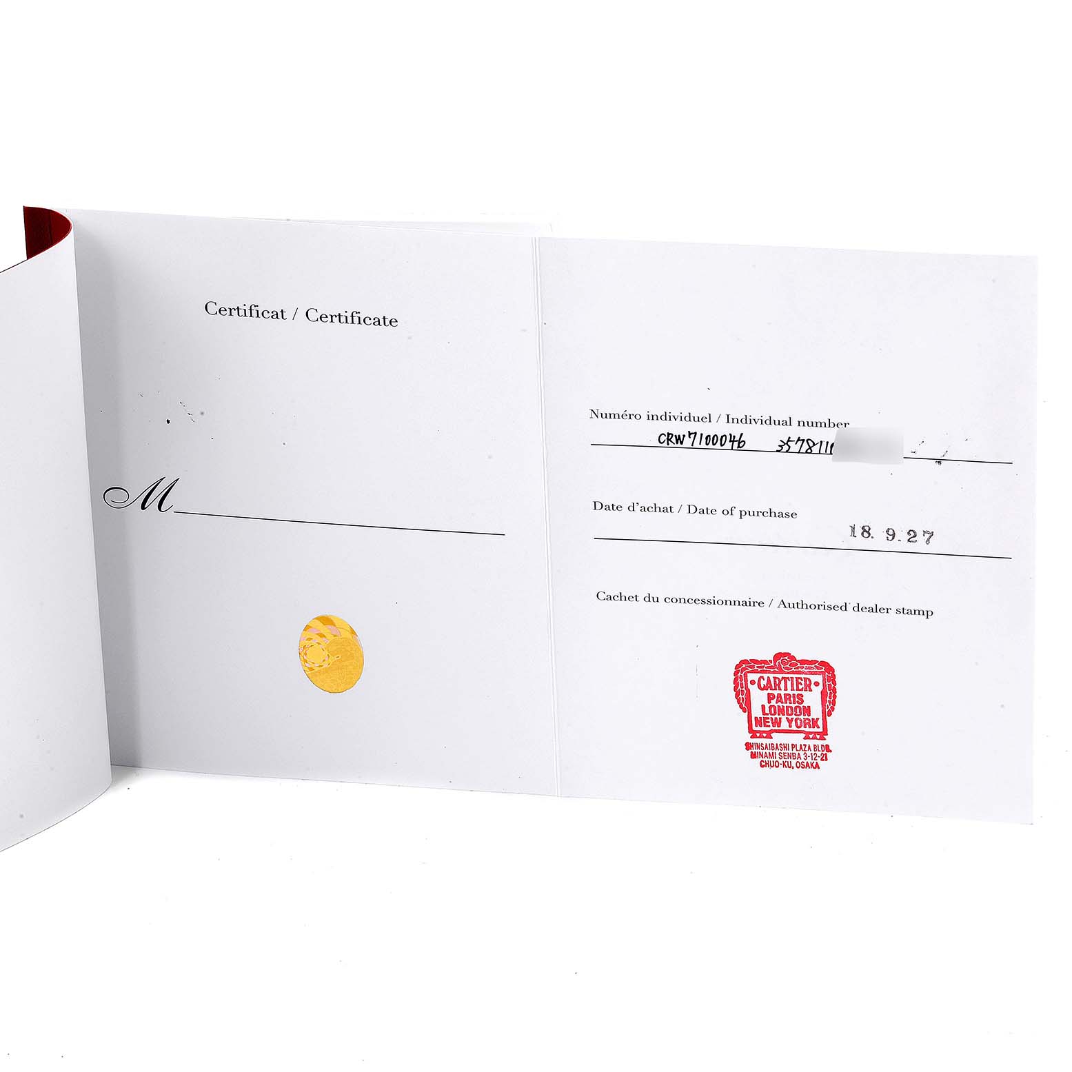 This image shows an open certificate booklet for a Calibre de Cartier watch by Cartier, displaying individual number, date of purchase, and dealer stamp.