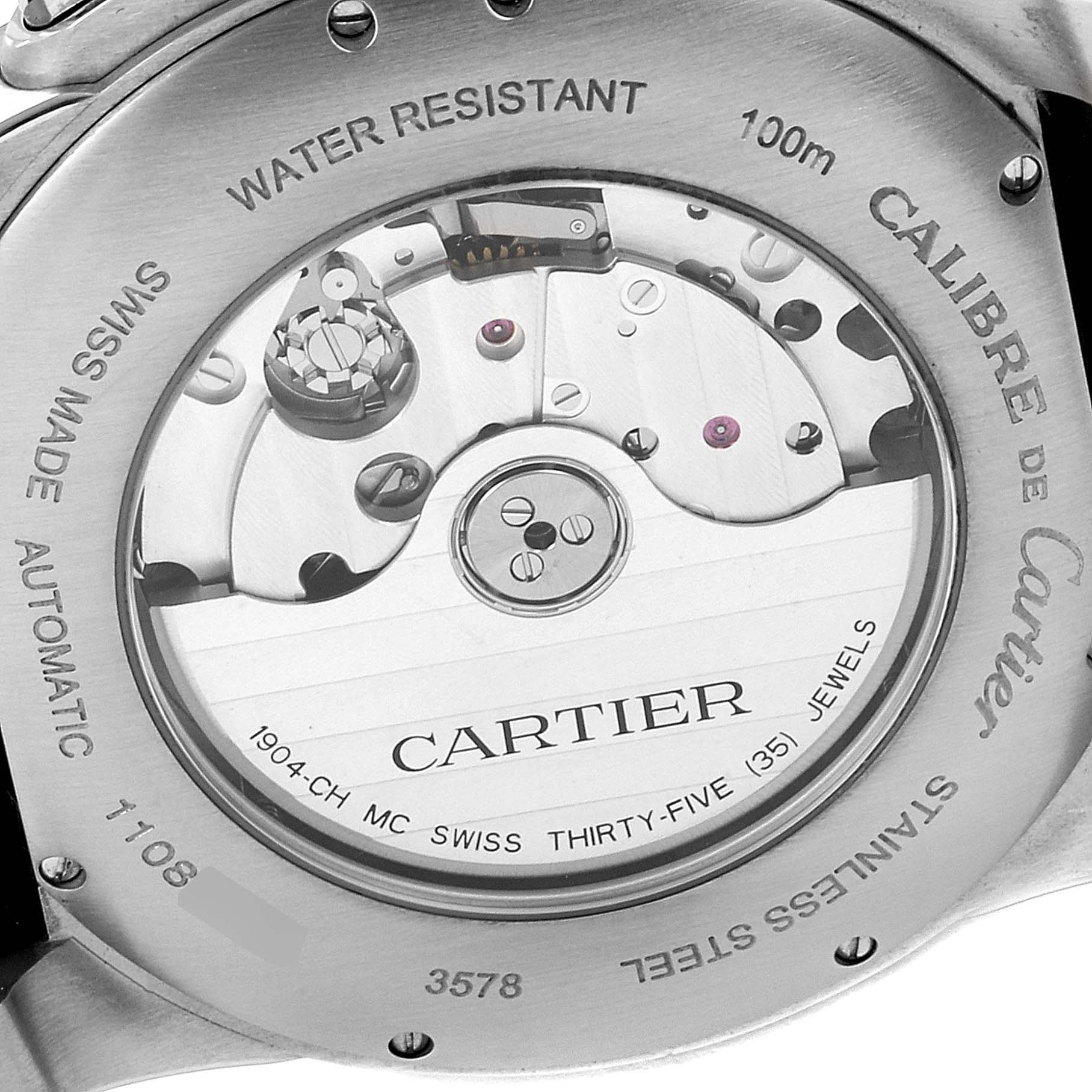 The image shows the back view of the Calibre de Cartier watch by Cartier, displaying its movement and engravings.