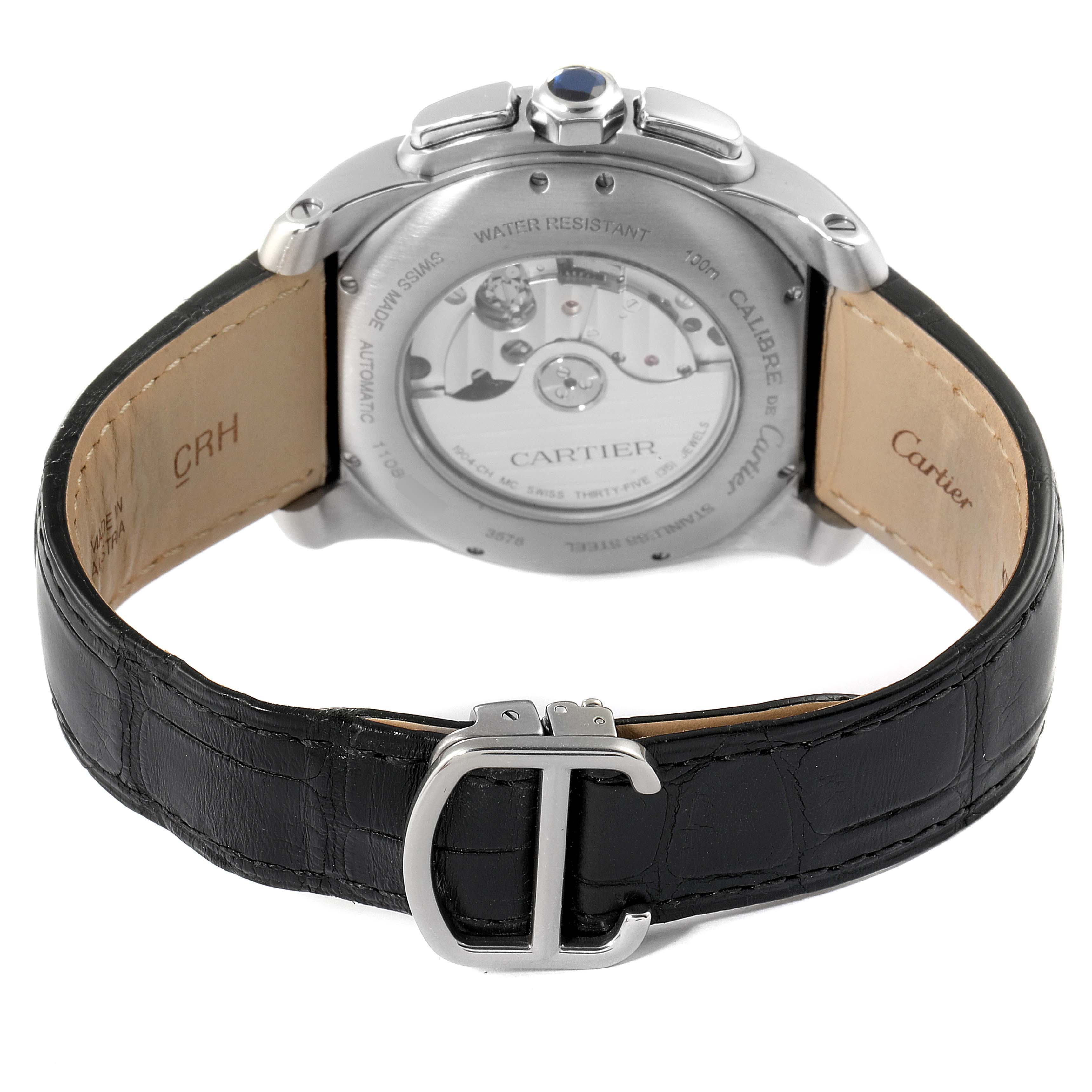 The image shows the back view of the Calibre de Cartier watch by Cartier, highlighting the case back and black leather strap with a "C" buckle.