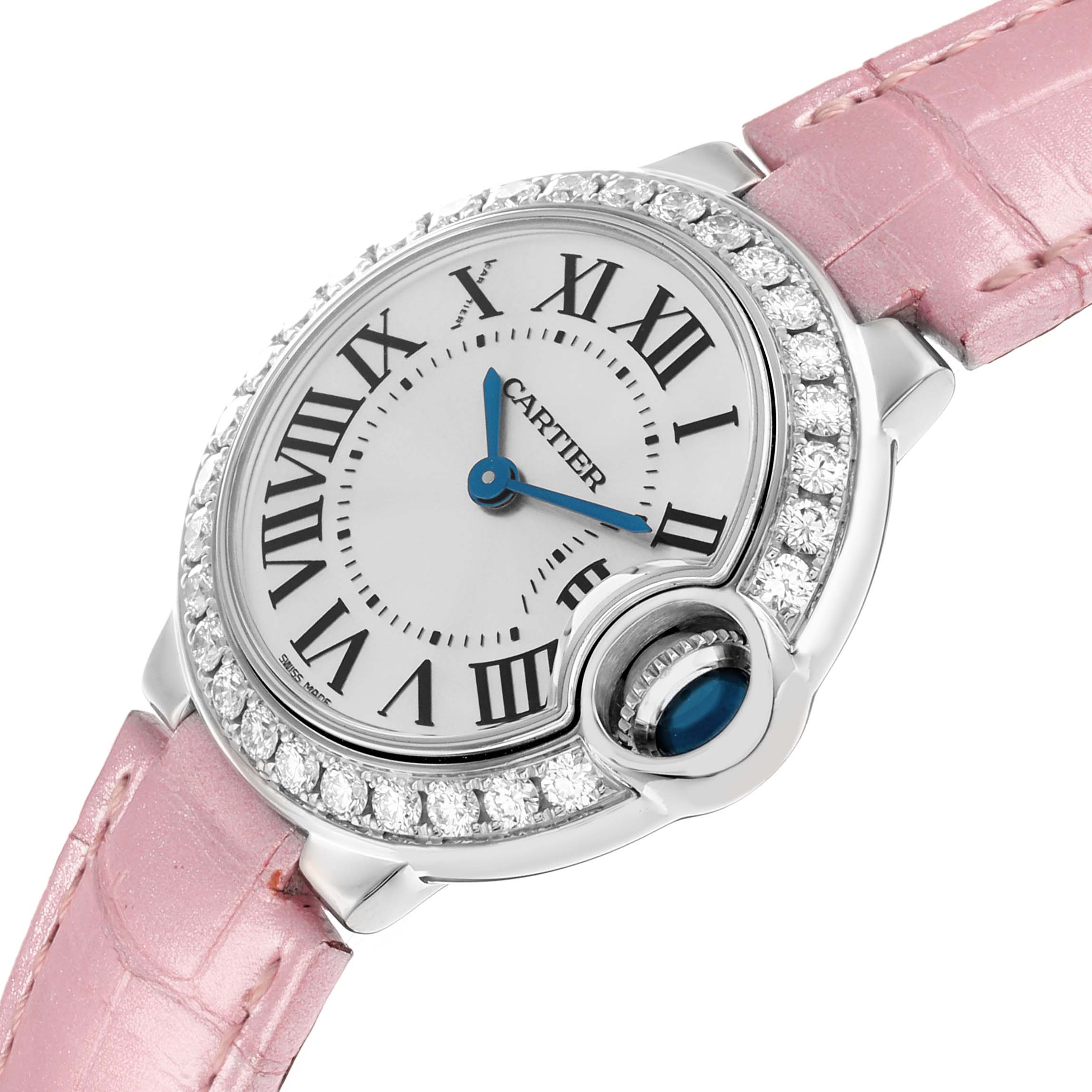 The Cartier Ballon Bleu WE900351 Women
s White Gold Silver Dial watch is shown at an angle highlighting its pink strap, diamond bezel, and blue cabochon crown.