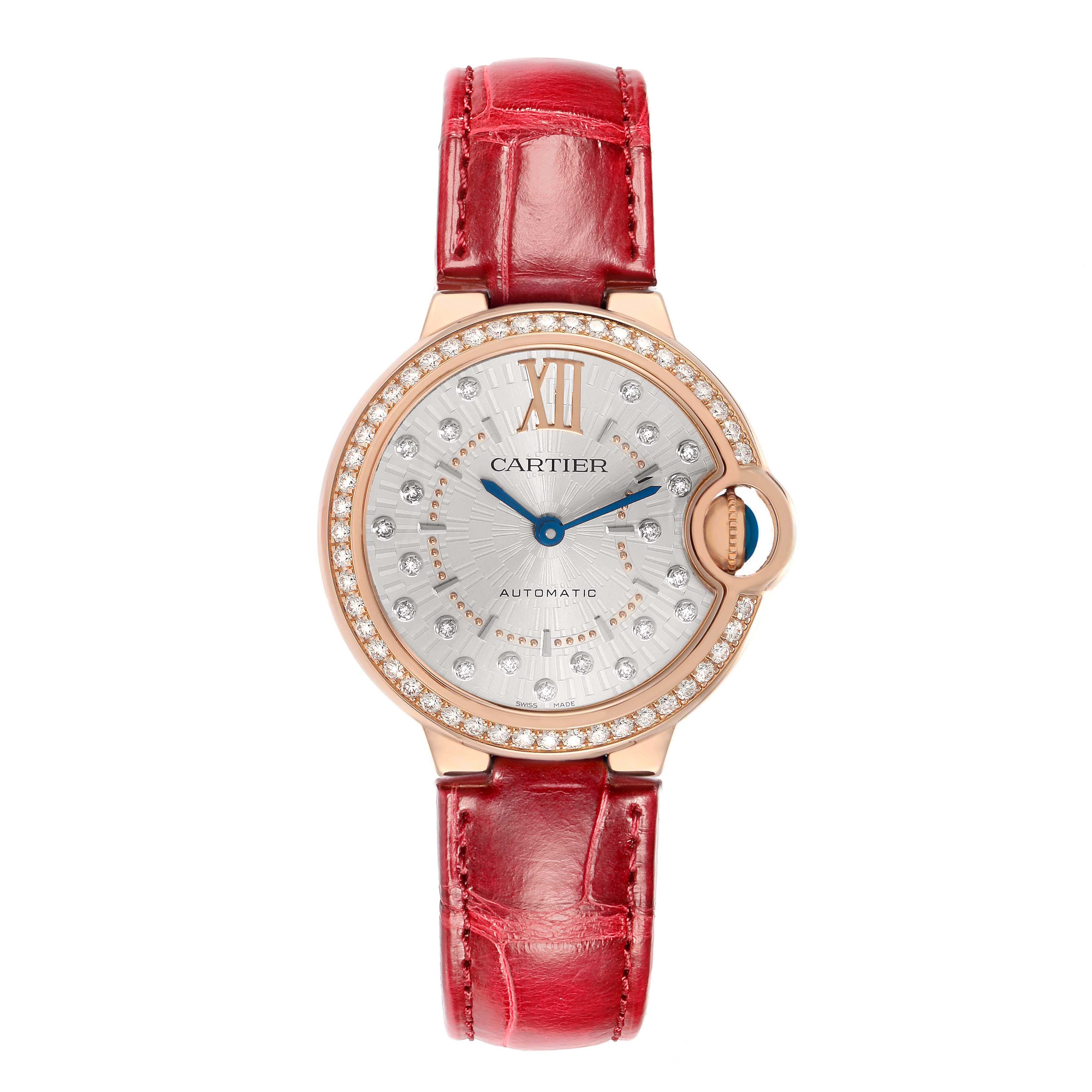 The Cartier Ballon Bleu WJBB0080 Women's Rose Gold Silver Dial watch is shown from the front, featuring a red strap, diamond-set bezel, and silver dial.