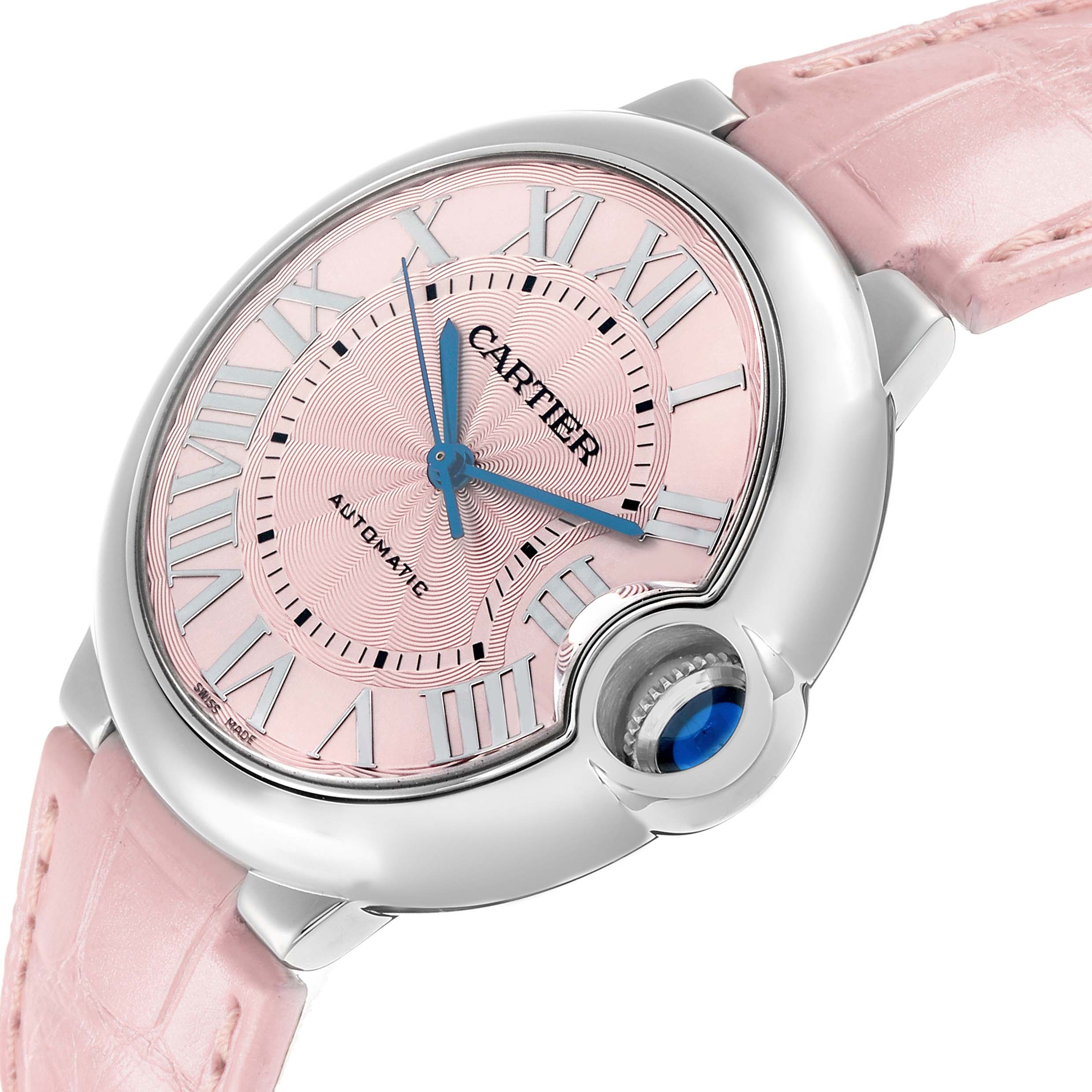 The Cartier Ballon Bleu WSBB0007 Women
s Stainless Steel Pink Dial watch is shown from a front angle, highlighting its pink dial, Roman numerals, and crown with a blue cabochon.