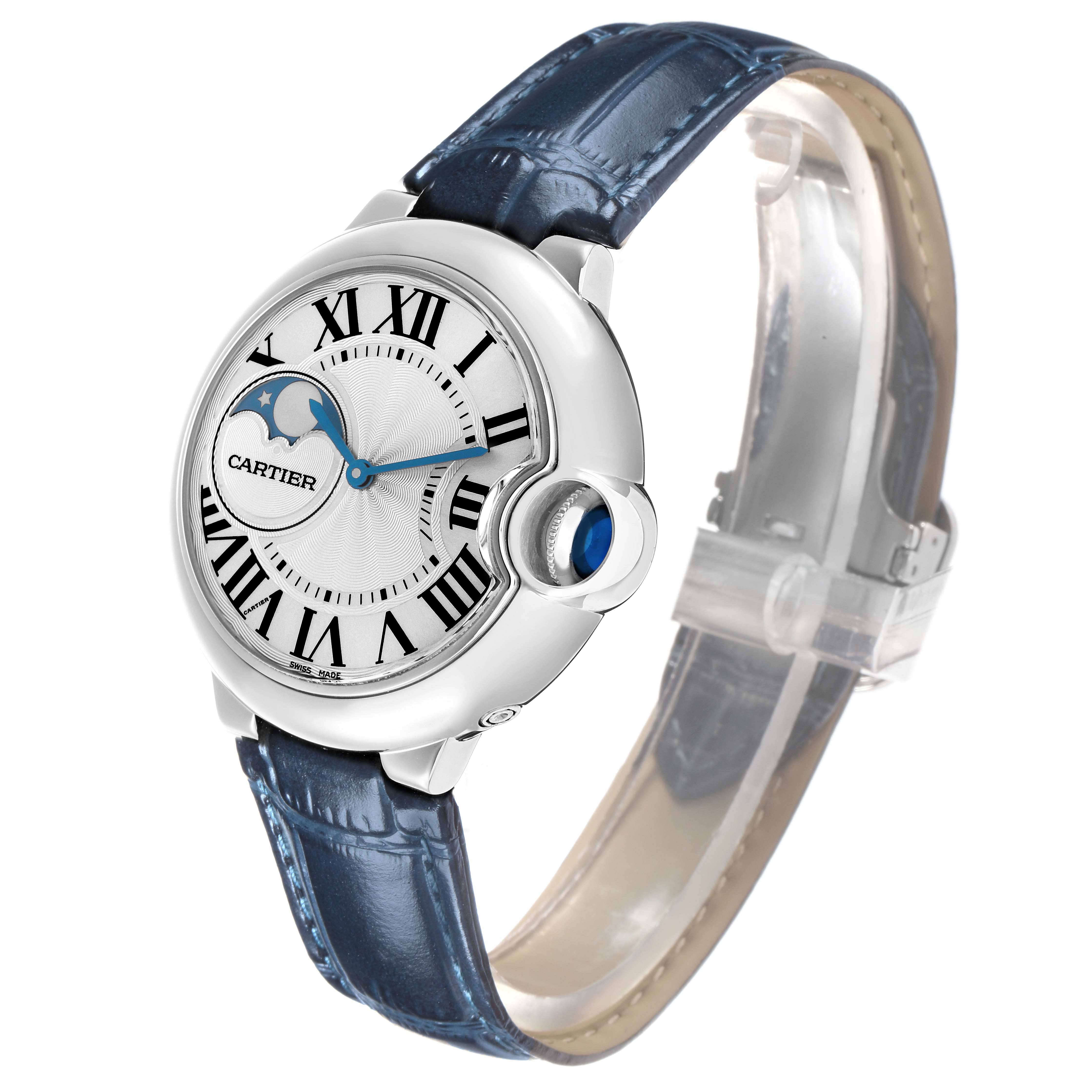 The Cartier Ballon Bleu WSBB0020 Men
s Stainless Steel Silver Dial watch is shown at a slight angle, highlighting its round case, Roman numerals, blue hands, and leather strap.