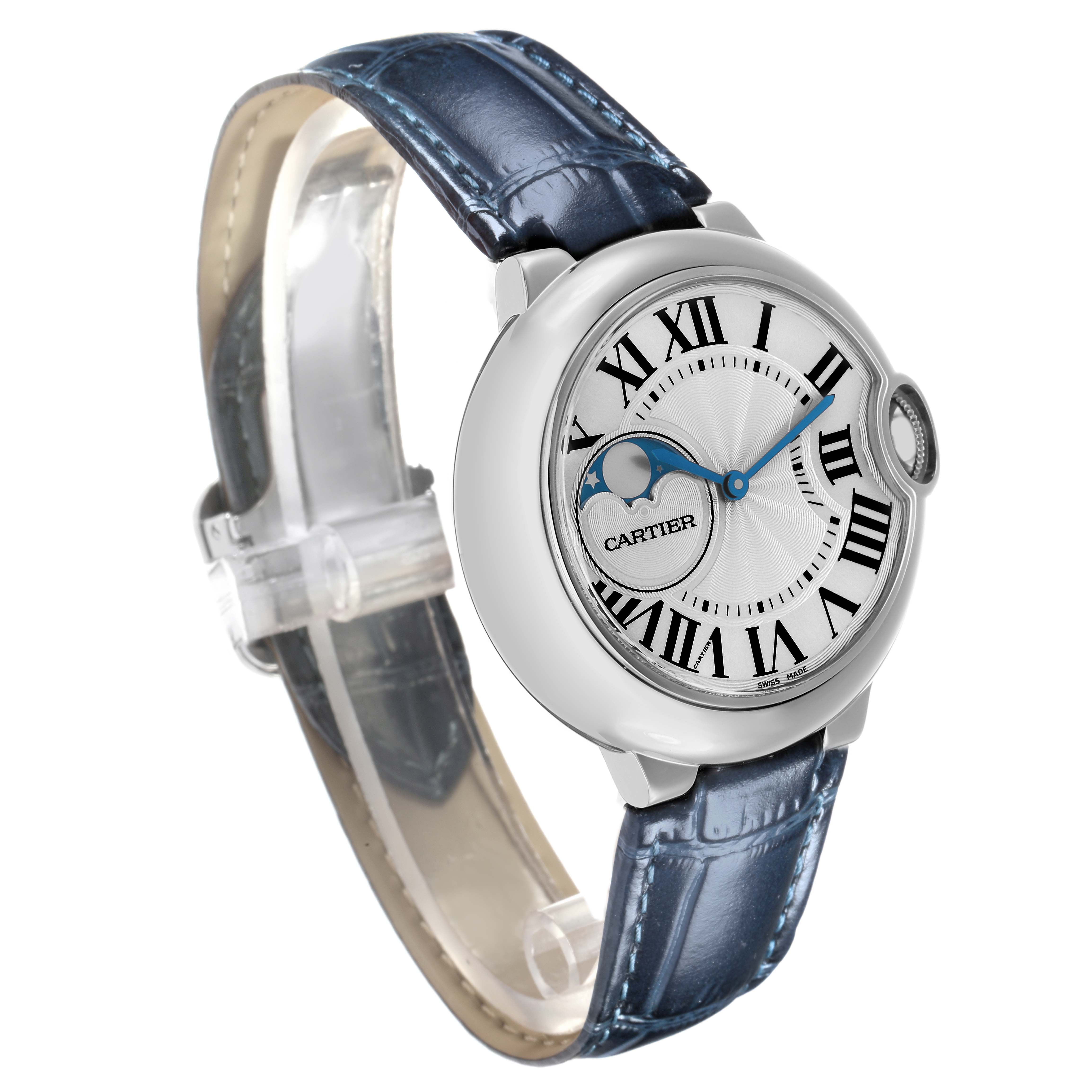 The Cartier Ballon Bleu WSBB0020 Men
s Stainless Steel Silver Dial watch is shown in a three-quarter angle displaying the face, Roman numerals, crown, and blue leather strap.