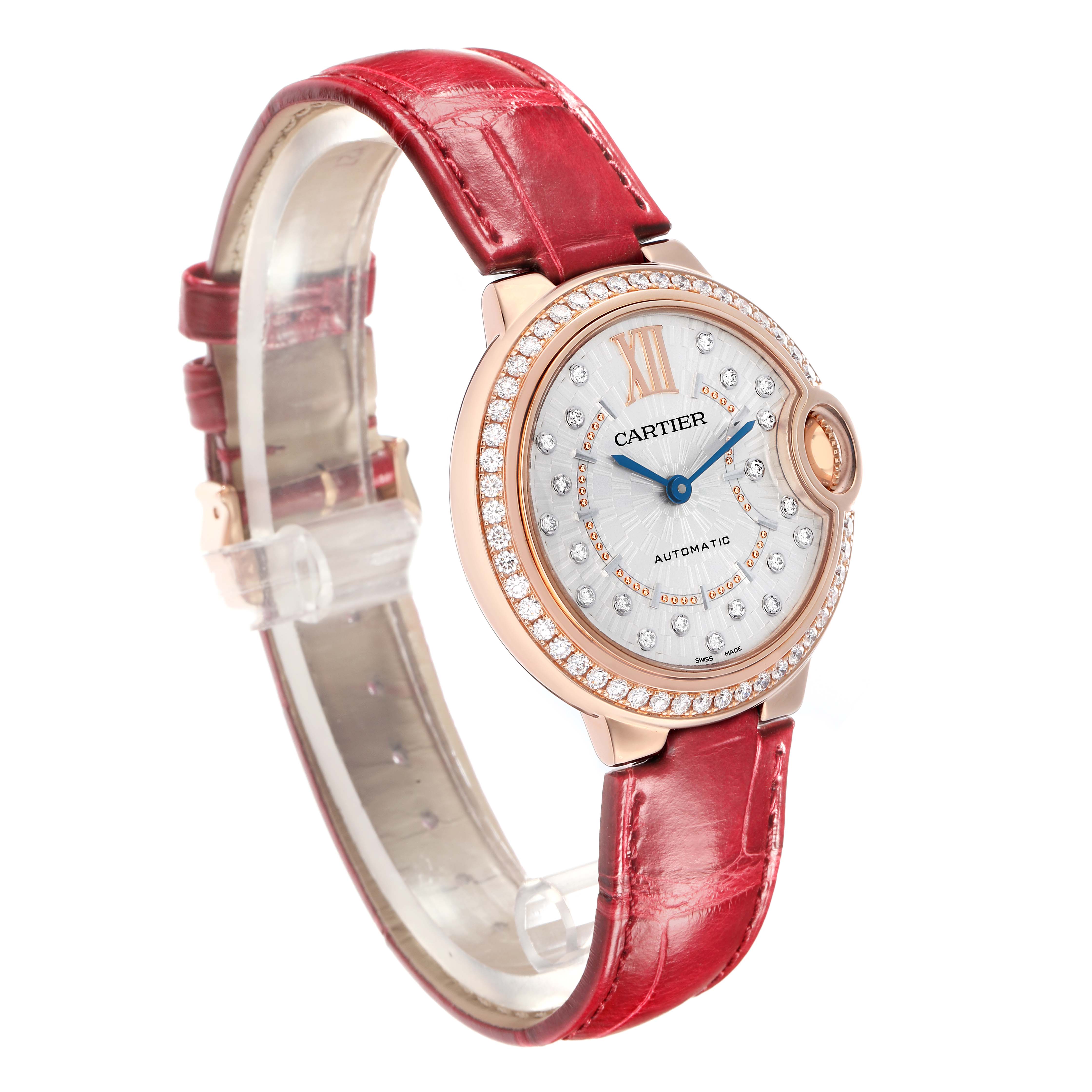 The Cartier Ballon Bleu WJBB0080 Women
s Rose Gold Silver Dial watch is shown at a slight angle, highlighting the face, red strap, and diamond details on the bezel.