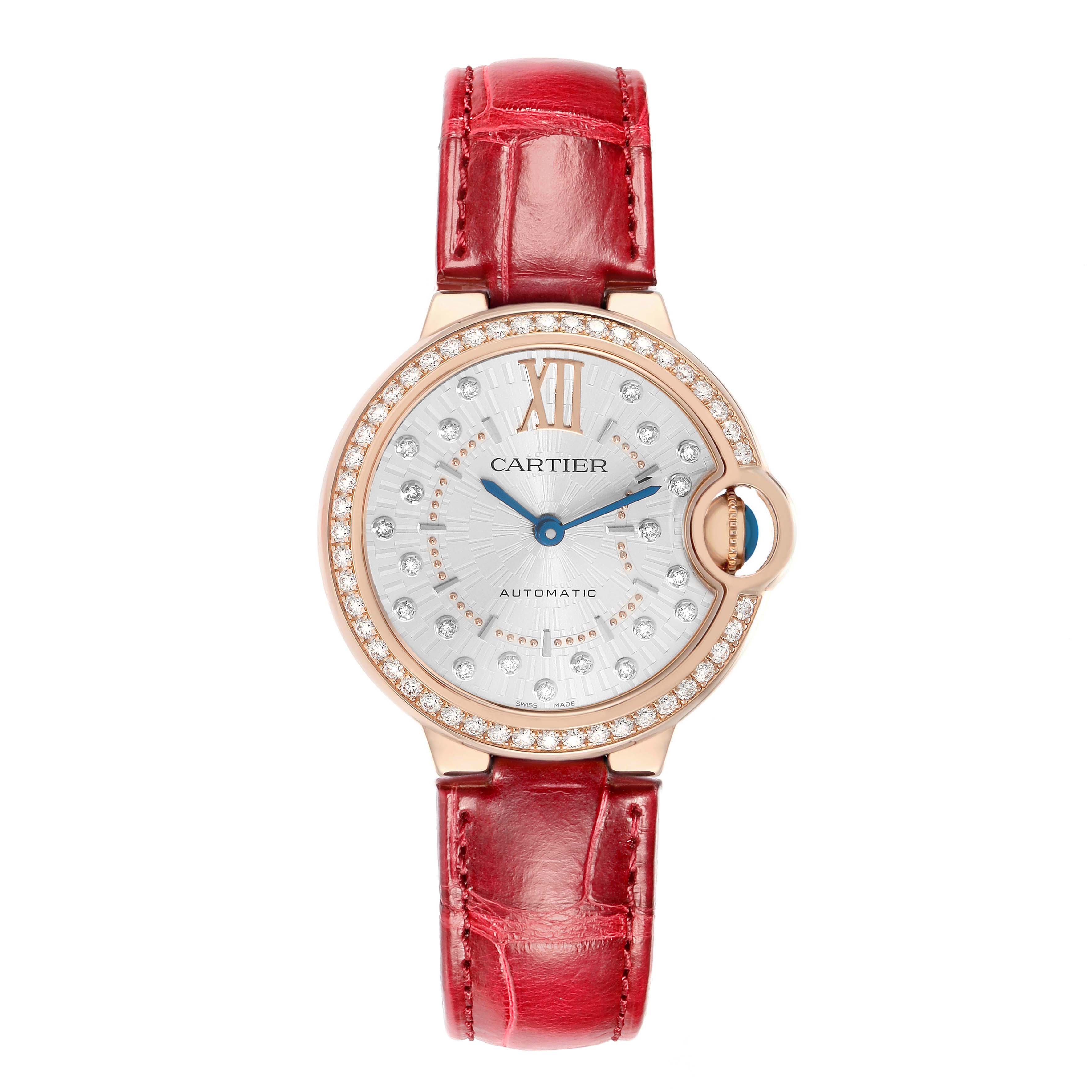 The Cartier Ballon Bleu WJBB0080 Women
s Rose Gold Silver Dial watch is shown from a top-down angle, highlighting the red strap and diamond-studded bezel.