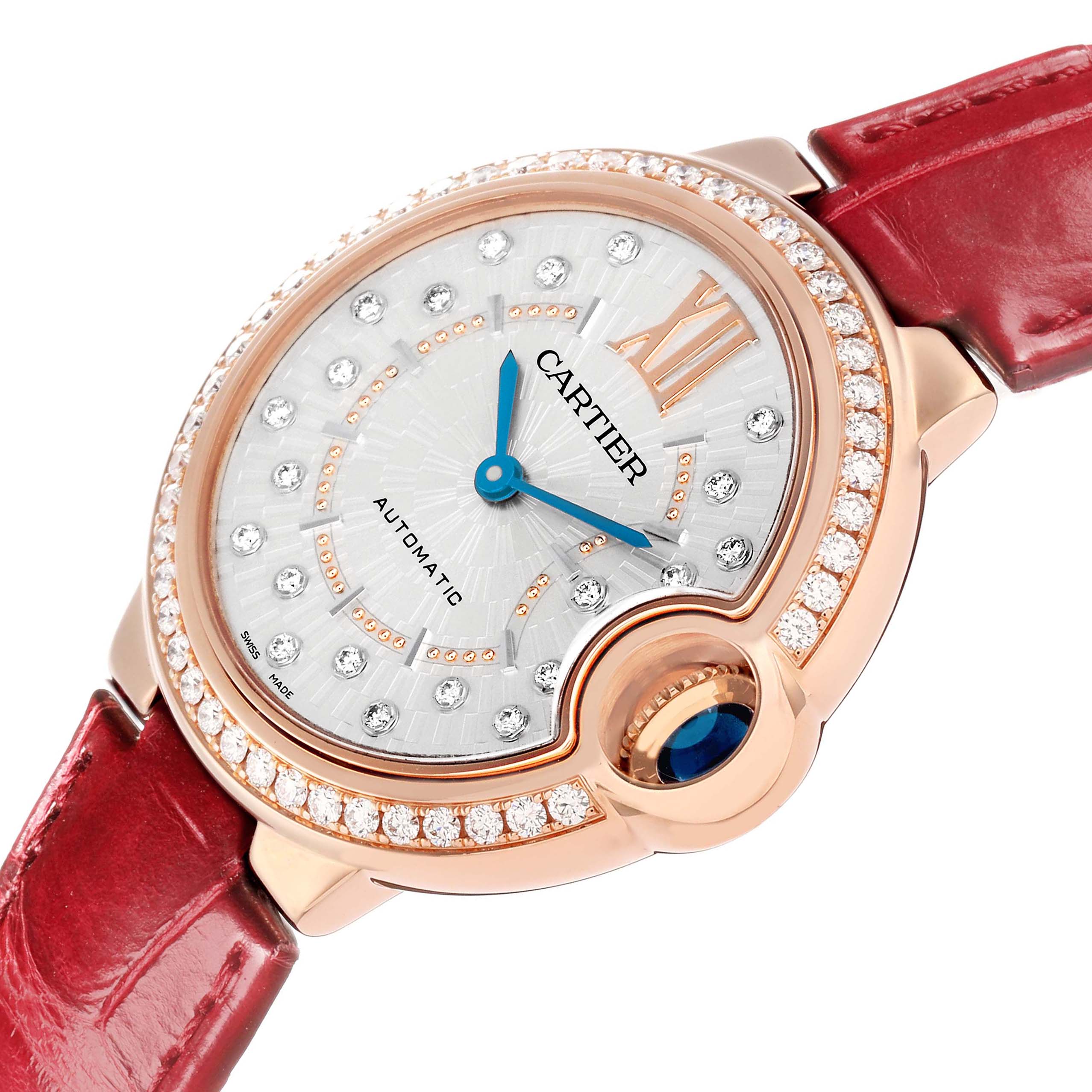 The Cartier Ballon Bleu WJBB0080 Women
s Rose Gold Silver Dial watch is shown at an angle highlighting the face, crown, and red strap.
