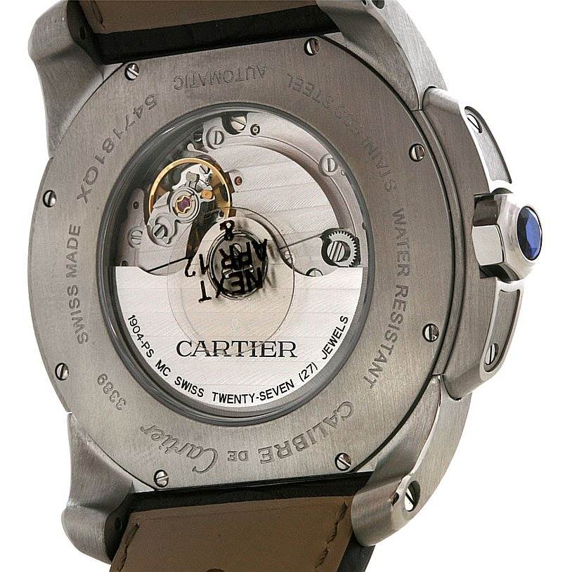 The image shows the back of the Calibre de Cartier watch by Cartier, highlighting its automatic movement and inner mechanism.