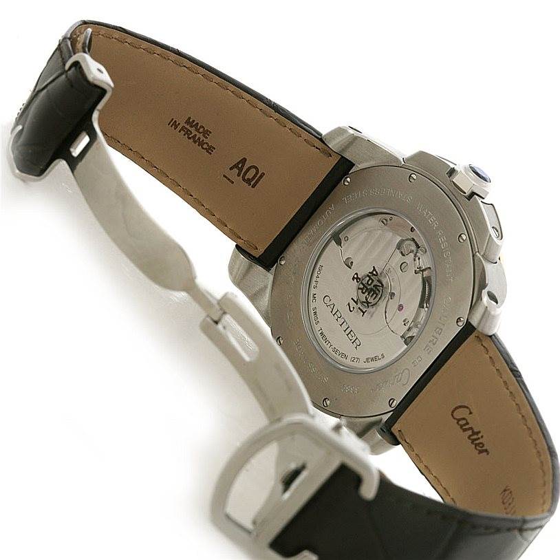 The image shows the back view of a Calibre de Cartier watch by Cartier, highlighting the transparent case back and straps.