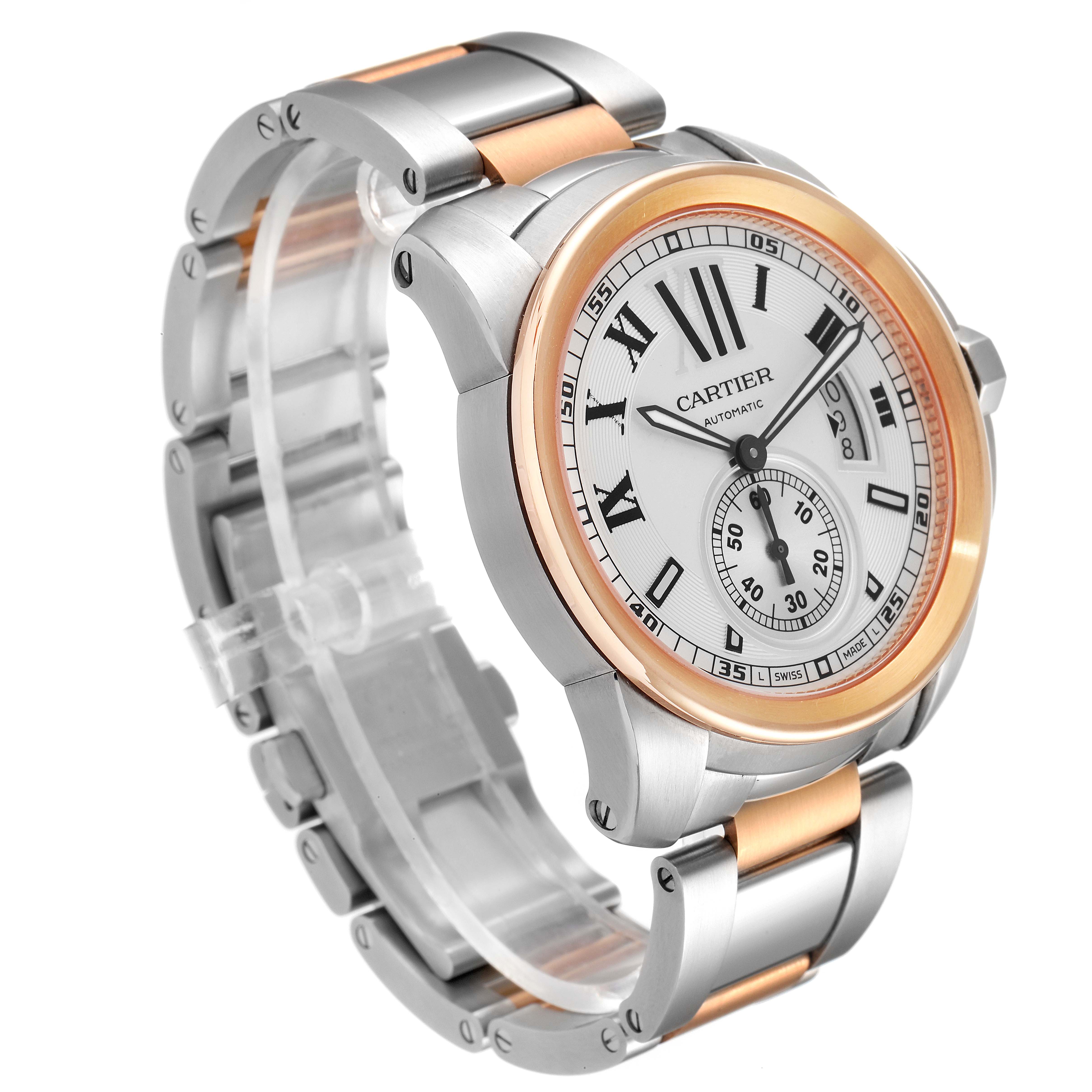 The image shows a Calibre de Cartier watch by Cartier at an angle highlighting the face, bezel, and metal strap.