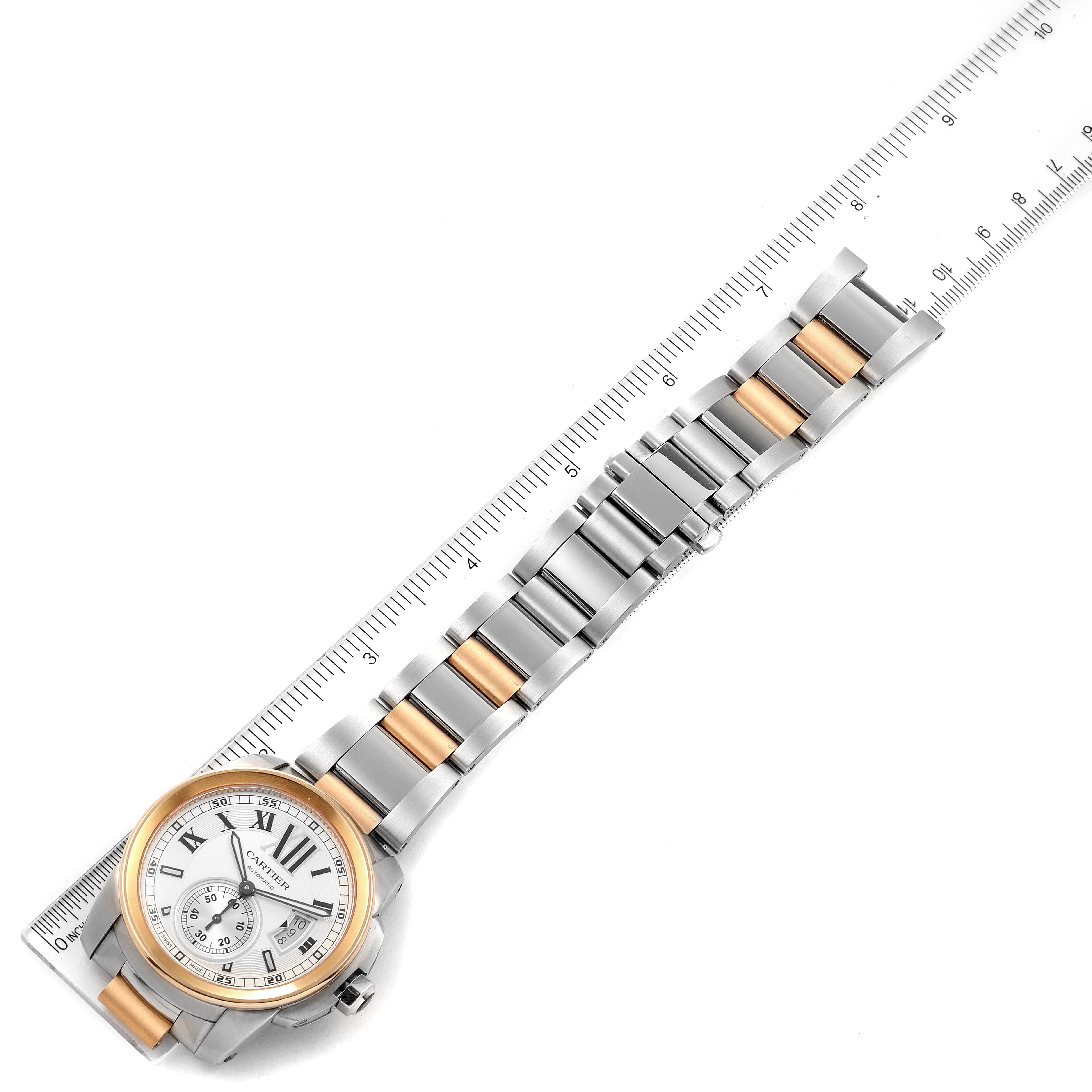 The image shows a Calibre de Cartier watch by Cartier, displaying the face and strap with a ruler for scale.