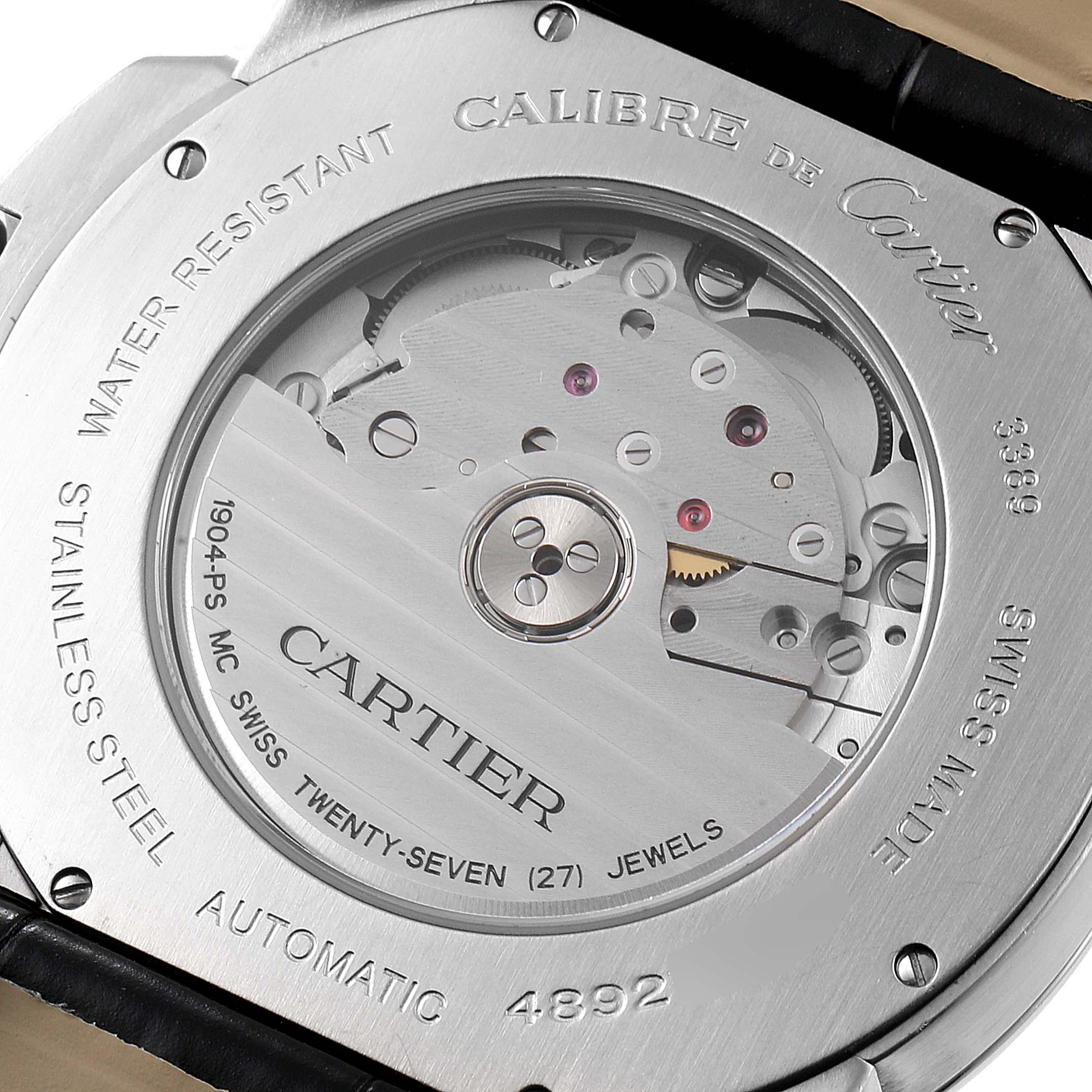 This image shows the back of a Calibre de Cartier watch by Cartier, highlighting its automatic movement and inner mechanics.