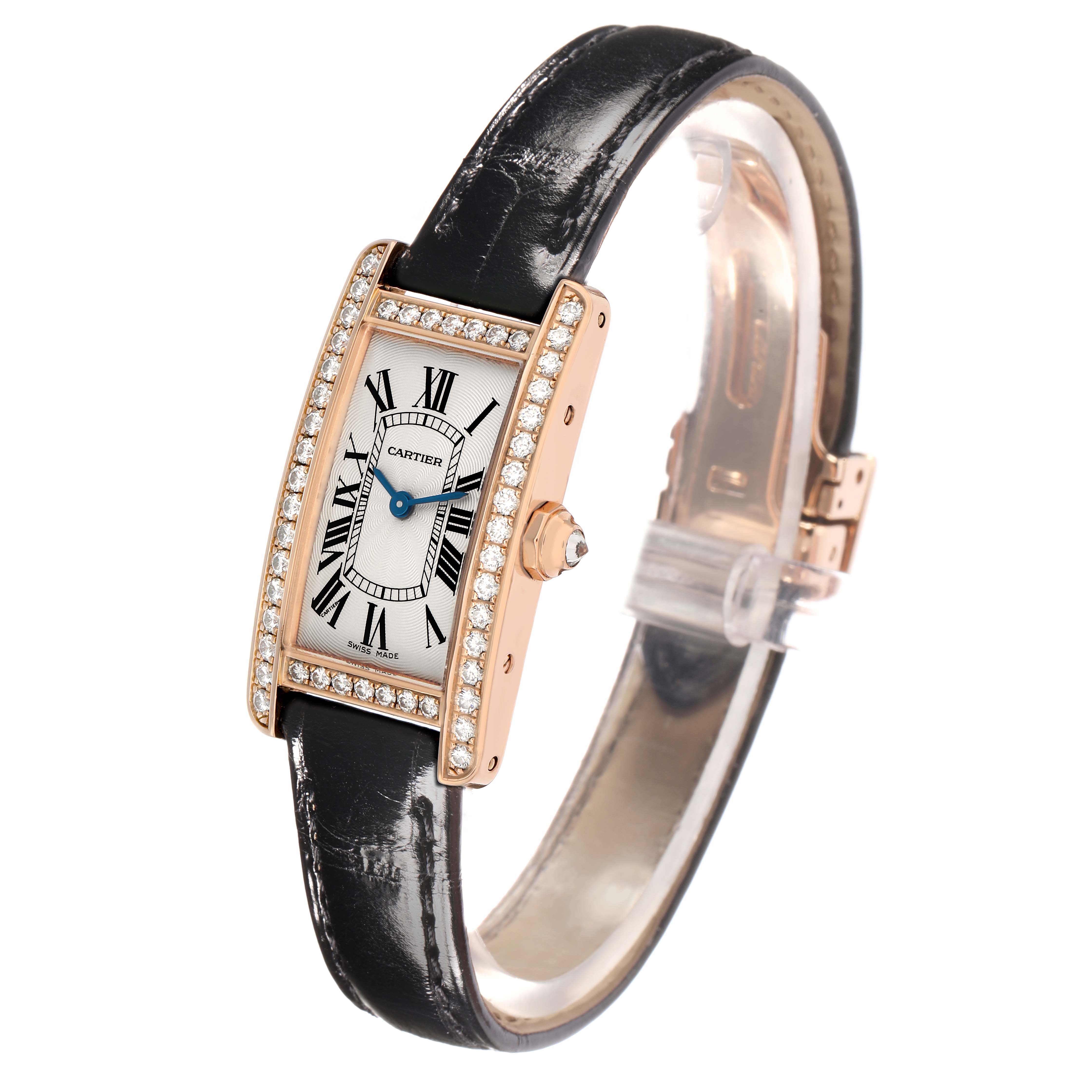 The Cartier Tank Americaine WJTA0002 Women
s Rose Gold Silver Dial watch is shown at an angled view, highlighting its rectangular dial, diamond-set bezel, and leather strap.