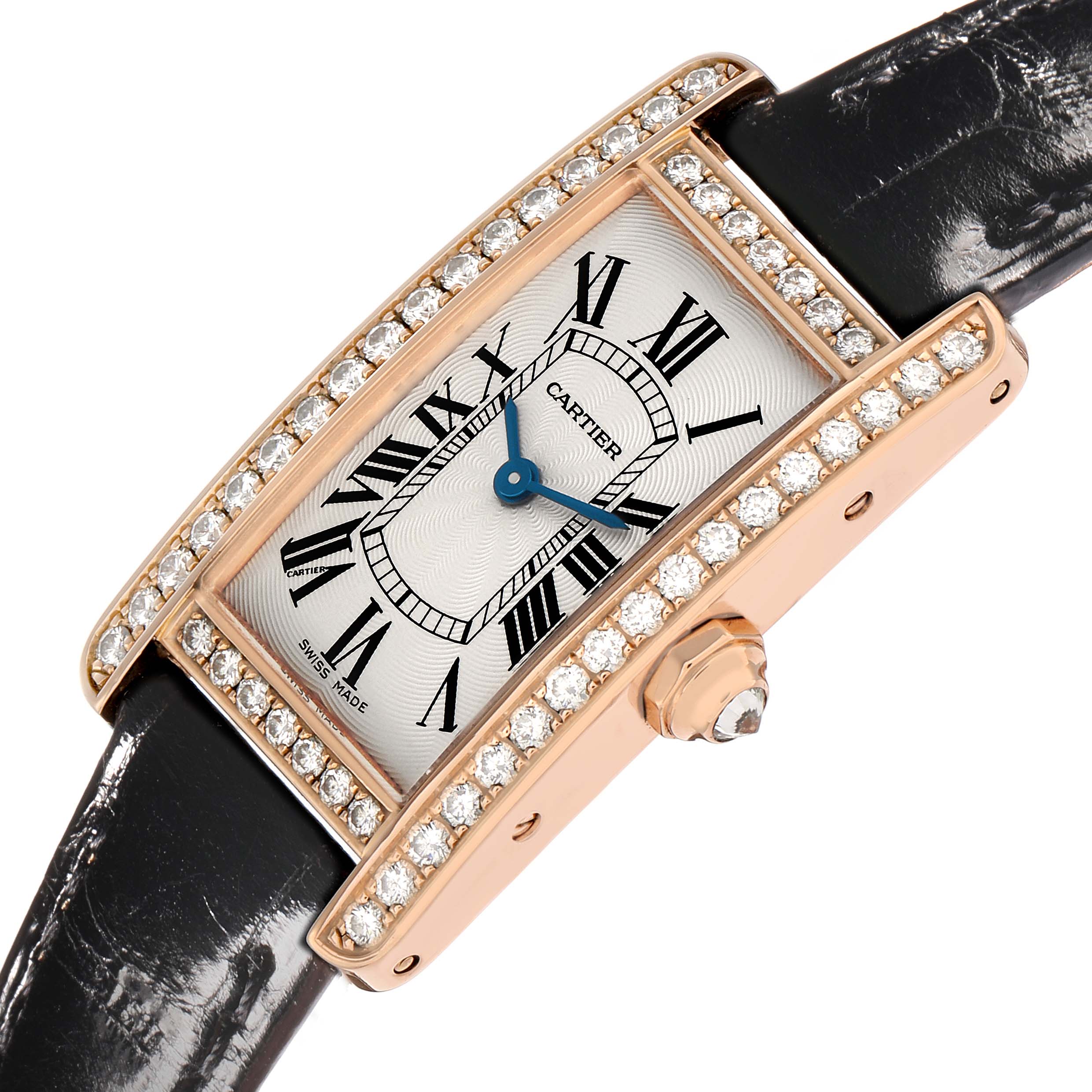 The Cartier Tank Américaine watch is shown at a tilted angle, highlighting its diamond-set bezel, dial, crown, and black leather strap.