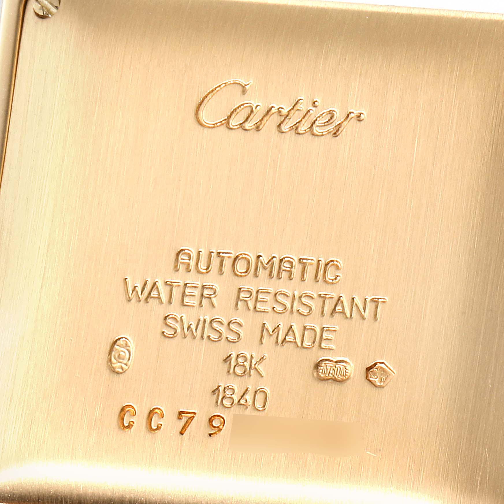 The image shows the case back of a Tank Francaise model by Cartier, highlighting its engravings.