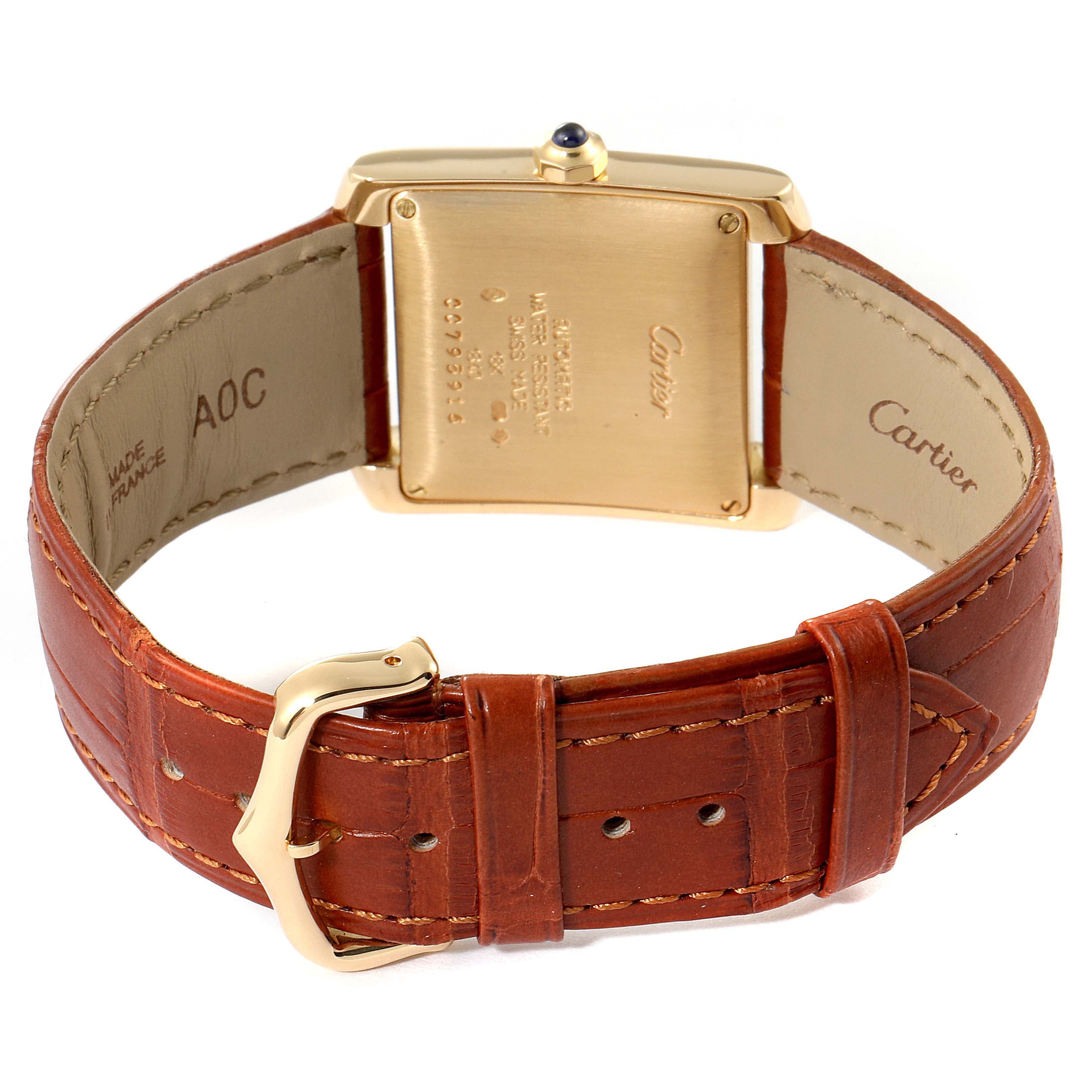 This image shows the back view of a Cartier Tank Francaise W5000156 Men's Yellow Gold Silver Dial W5000156 Men's Yellow Gold Silver Dial watch with a brown leather strap and a gold buckle.