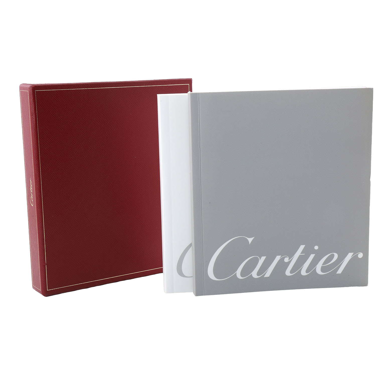 The image shows a red Cartier box and two books associated with the Cartier Tank Solo W1018855 Men's Yellow Gold Silver Dial model.