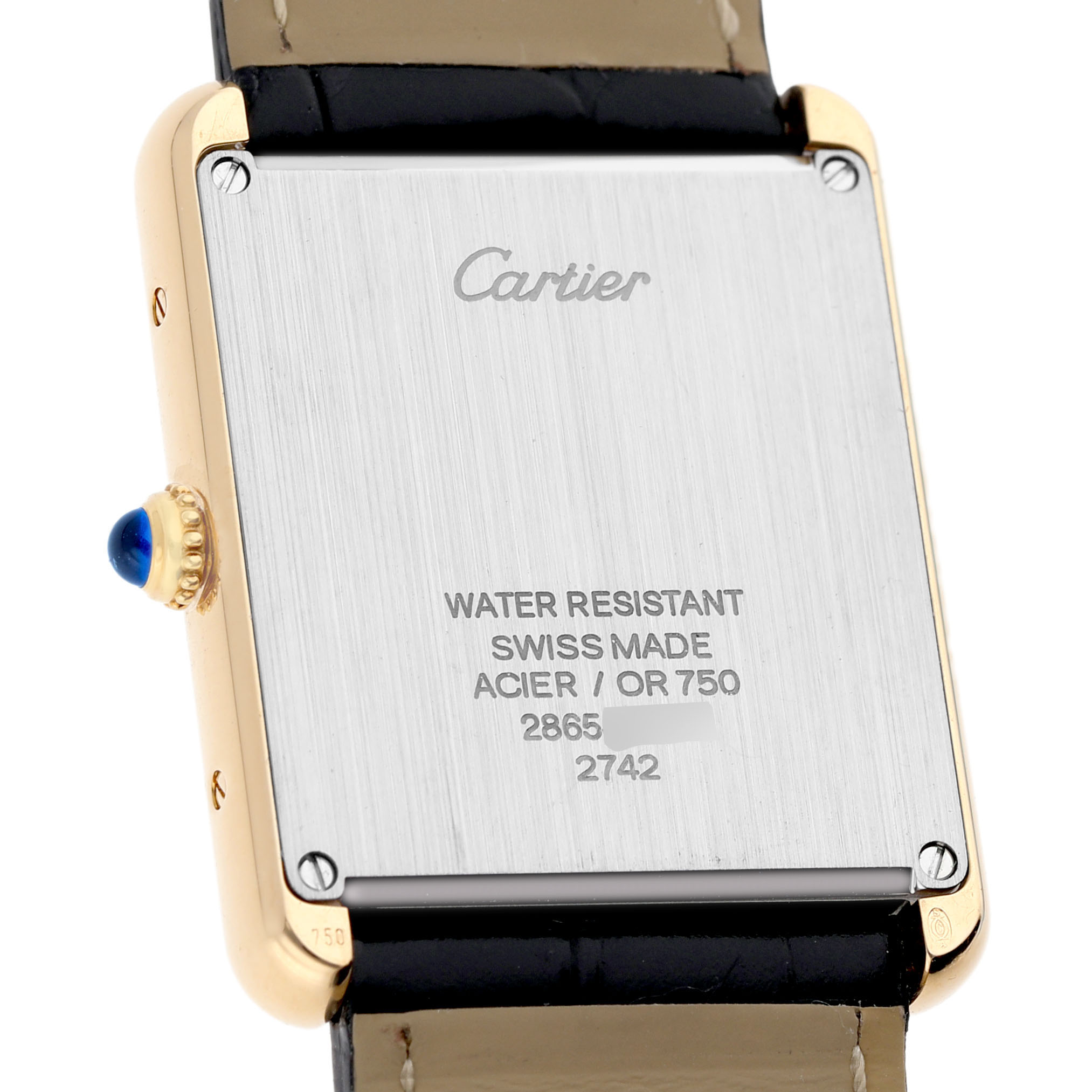 The image shows the back of a Cartier Tank Solo W1018855 Men's Yellow Gold Silver Dial watch, highlighting the engraving and crown with a blue cabochon.