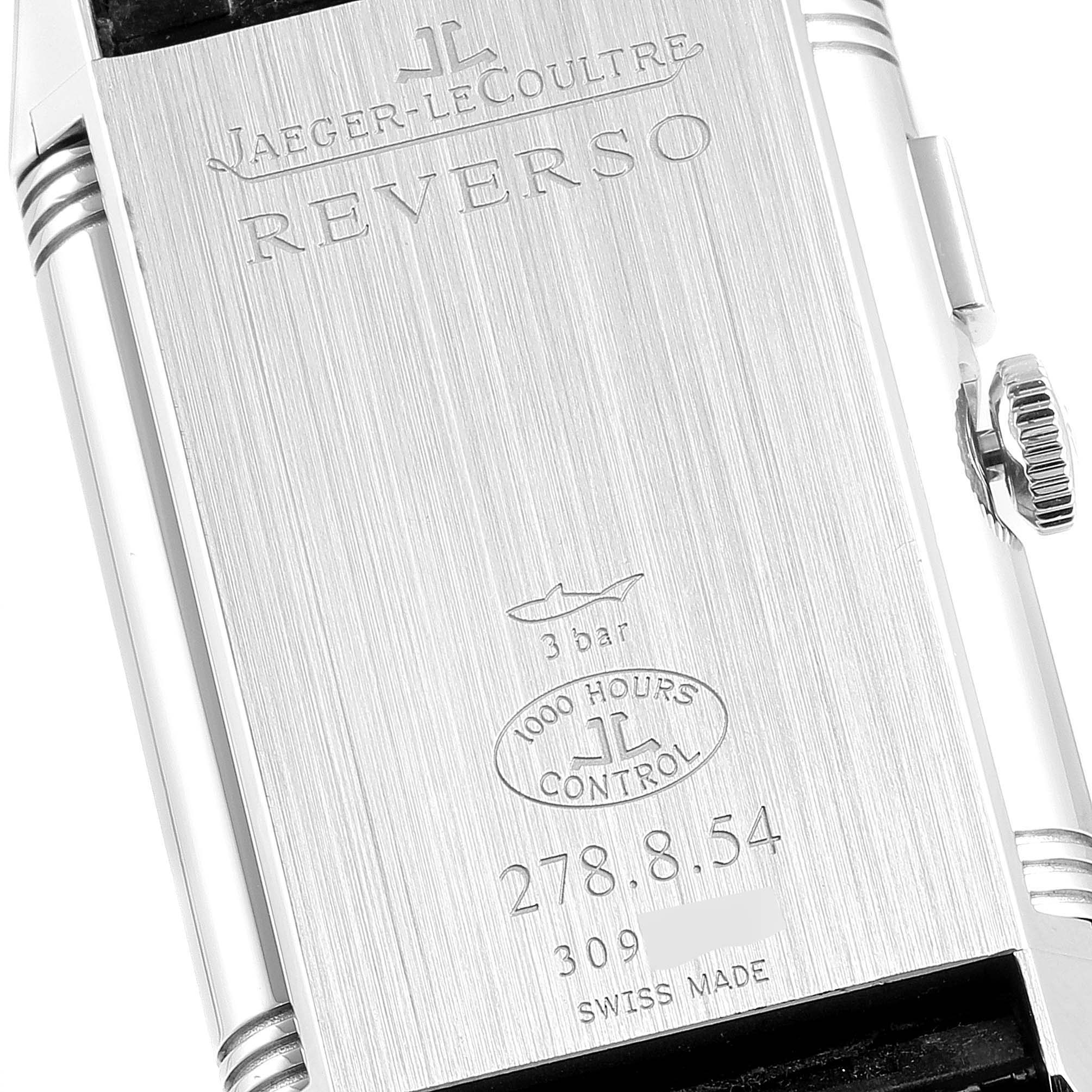 The image shows the back side of a Jaeger-LeCoultre Reverso watch, detailing its specifications and a portion of the crown.