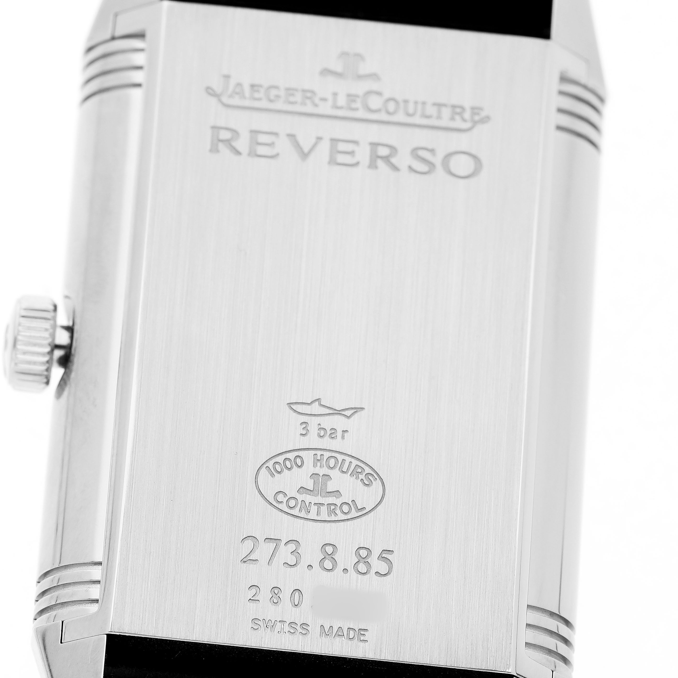 The image shows the back case of the Jaeger-LeCoultre Reverso watch, displaying engravings including water resistance and model details.