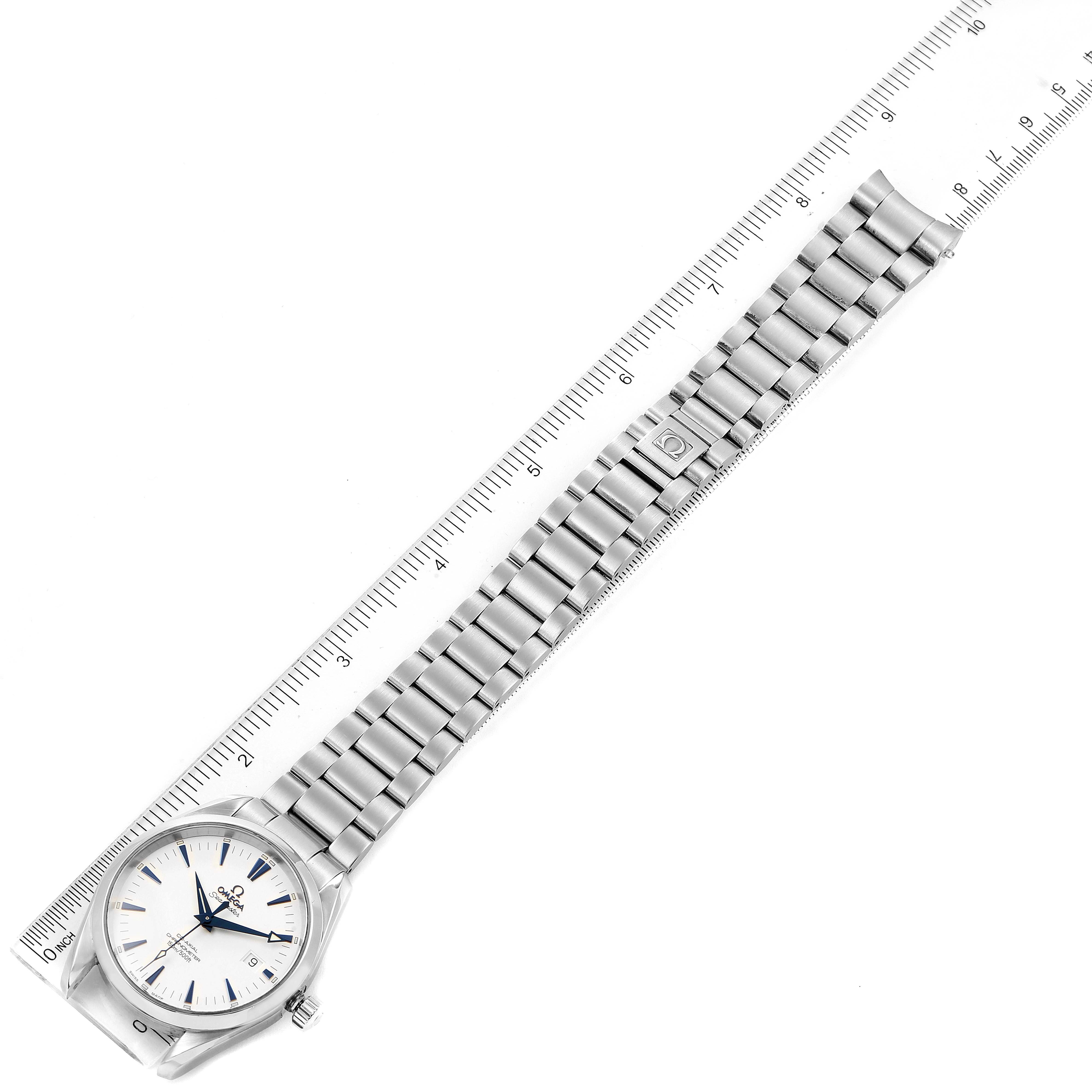 The image shows an Aqua Terra model by Omega at an angle with the face and full length of the metal bracelet displayed next to a ruler.
