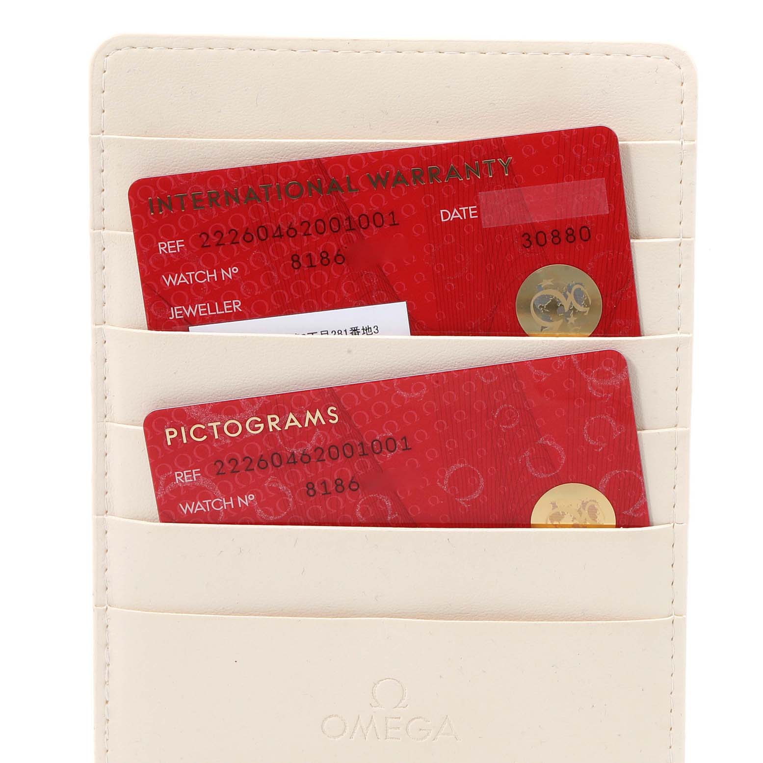 This image shows the international warranty and pictograms cards for the Omega Planet Ocean 222.60.46.20.01.001 Men's Rose Gold Black Dial 222.60.46.20.01.001 Men's Rose Gold Black Dial model, contained in a white card holder.