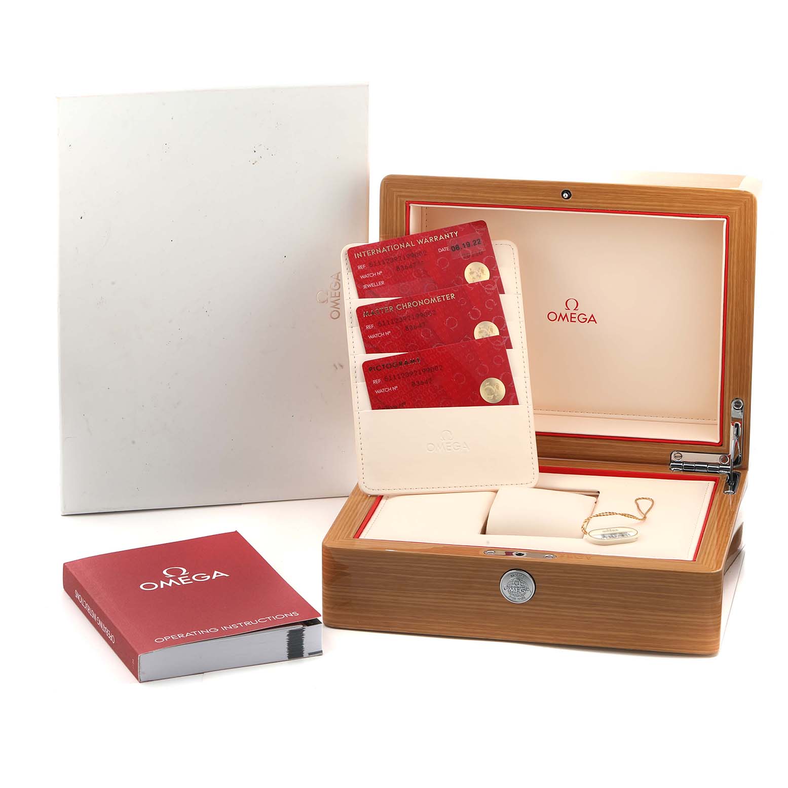 The image shows an Omega Museum 511.12.39.21.99.002 Men
s Stainless Steel Grey Dial model watch box, warranty cards, tags, and instructions, viewed from above.