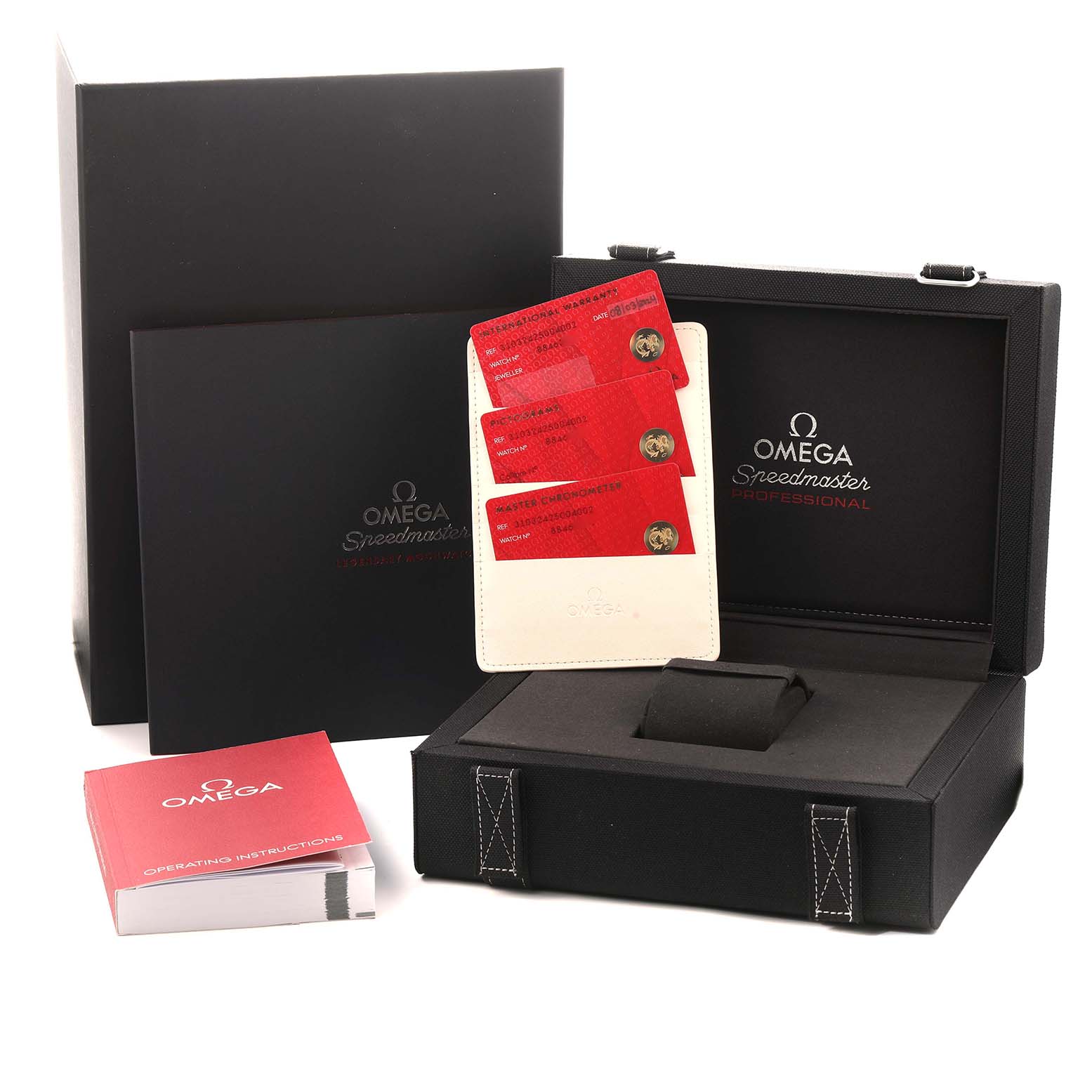 The image shows the Omega Speedmaster 310.32.42.50.04.002 Men
s Stainless Steel White Dial box, instruction manual, and warranty cards at an angle displaying all accessories.