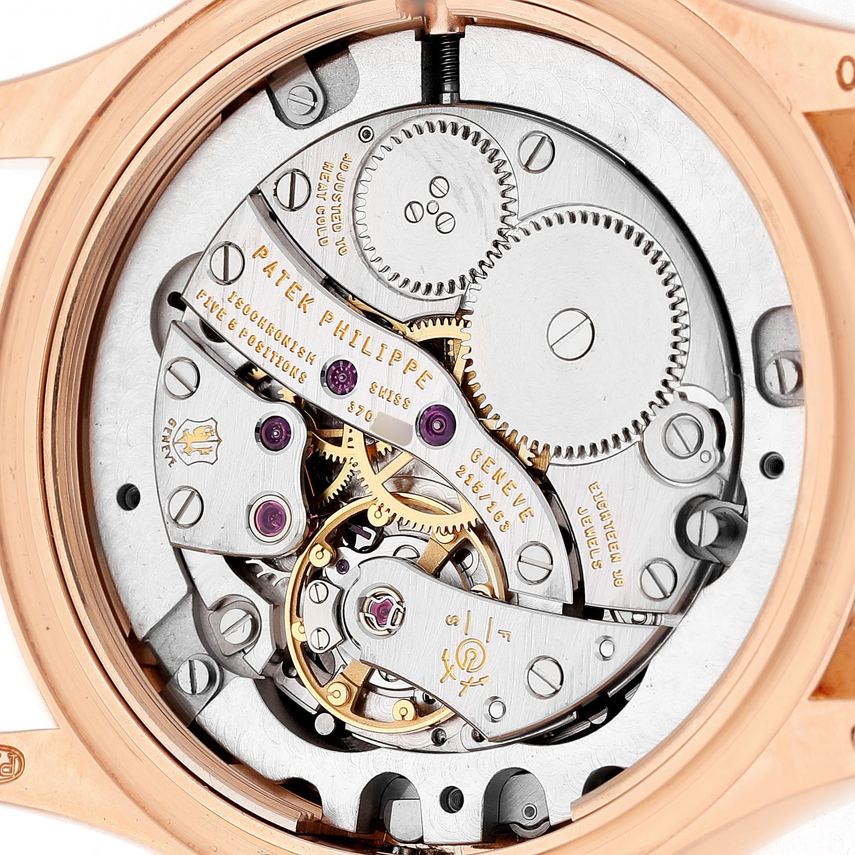 This image shows the movement from the back of the Patek Philippe Calatrava 4934R-001 Women's Rose Gold Brown Dial watch, highlighting gears and inscriptions.