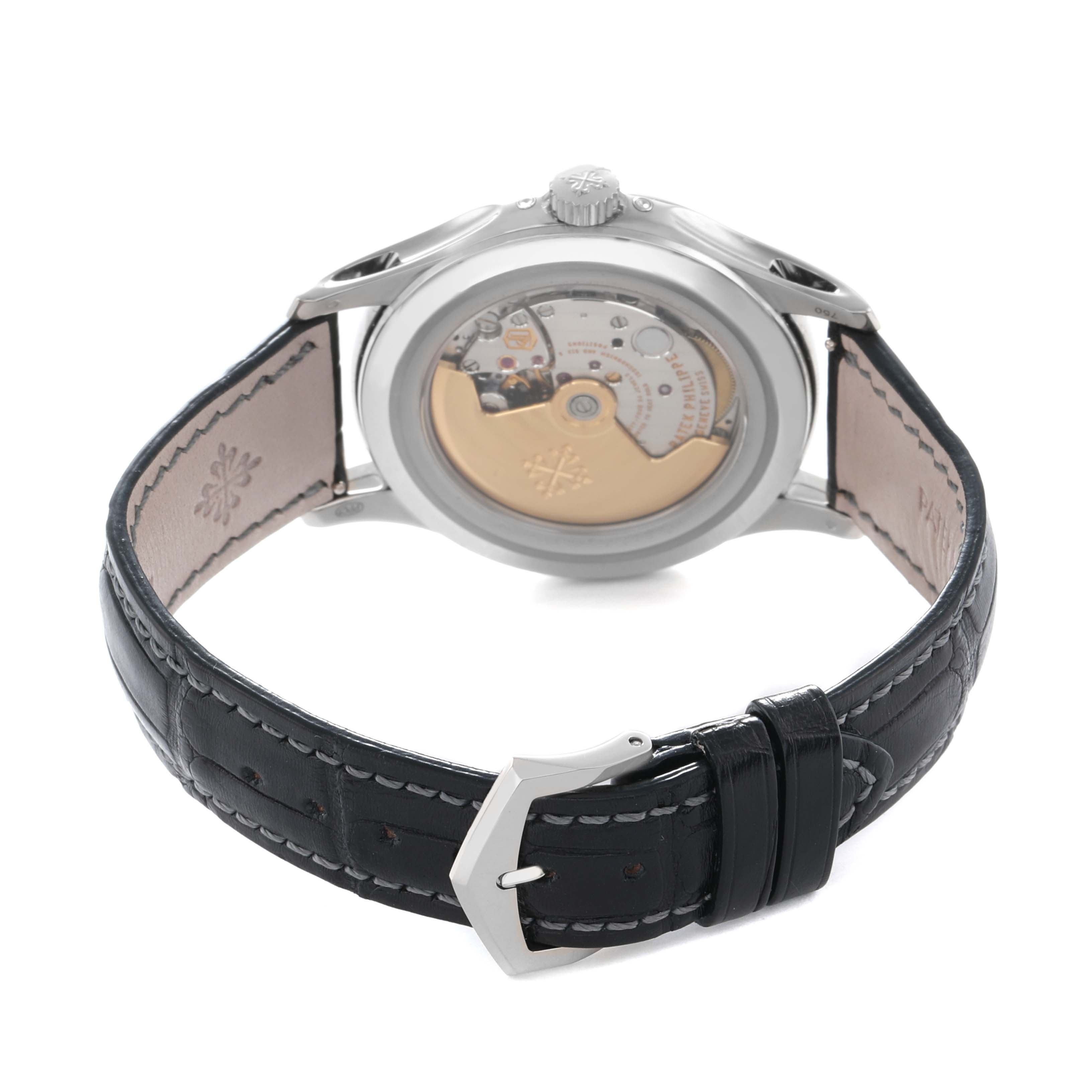 The image shows a Patek Philippe Complications 5205G Men
s White Gold Grey Dial model from the back, highlighting the movement and part of the leather strap.