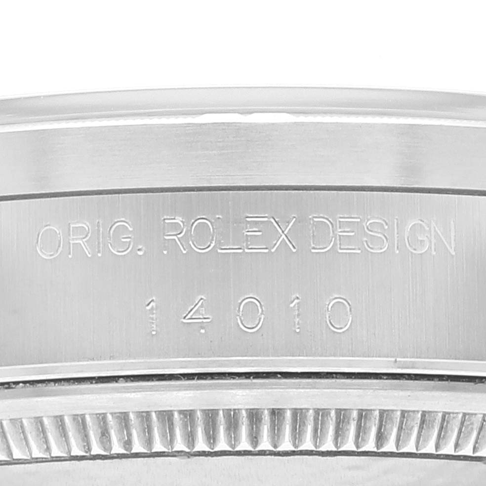 This close-up image shows the side of a Rolex Air-King 14010 Men's Stainless Steel Black Dial 14010 Men's Stainless Steel Black Dial watch case with the engraving of the serial number and design details.