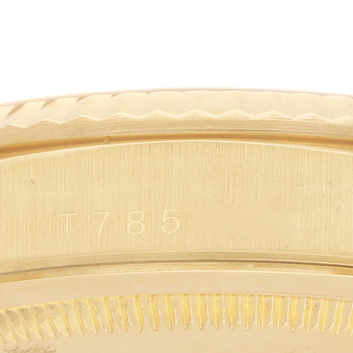 The image shows a close-up of the side of a Rolex Datejust 16238 Men
s Yellow Gold Champagne Dial, displaying the case and part of the fluted bezel.