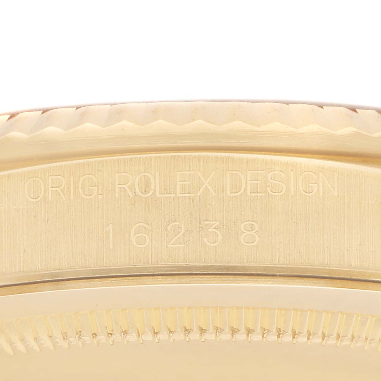 The image shows a close-up view of the side of a Rolex Datejust 16238 Men
s Yellow Gold Champagne Dial, focusing on the engraved model number and "Orig. Rolex Design."