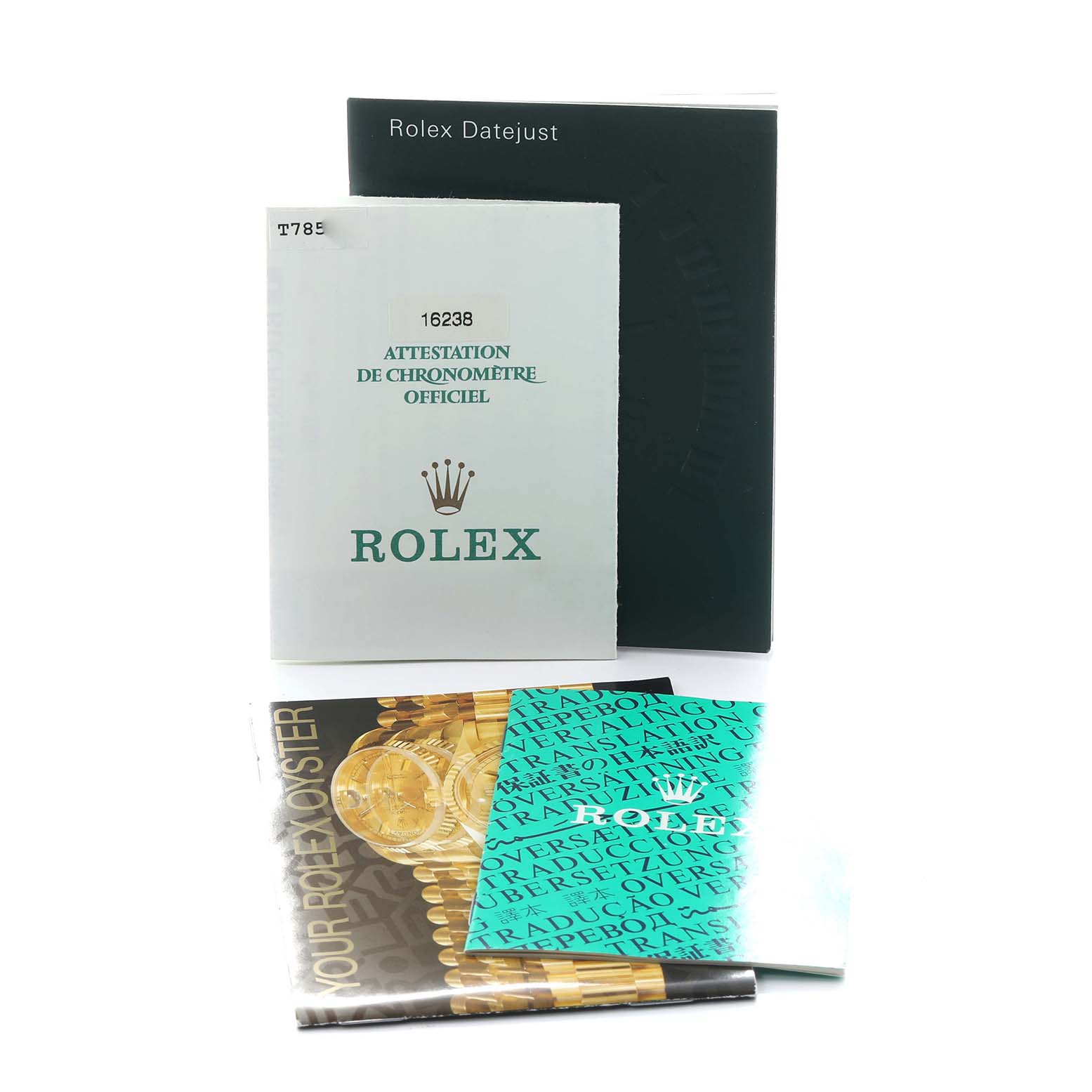 The image shows Rolex Datejust 16238 Men
s Yellow Gold Champagne Dial model booklets and documents from a front angle.