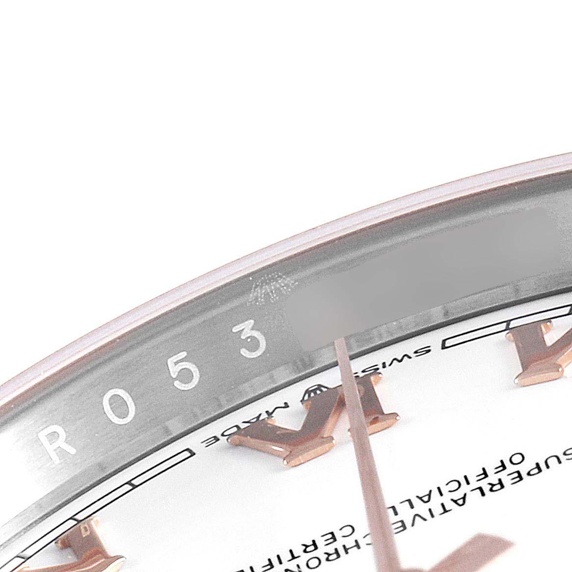 The image shows a close-up of the Rolex Datejust 126231 Men's Stainless Steel White Dial 126231 Men's Stainless Steel White Dial watch face, highlighting the serial number and part of the dial.