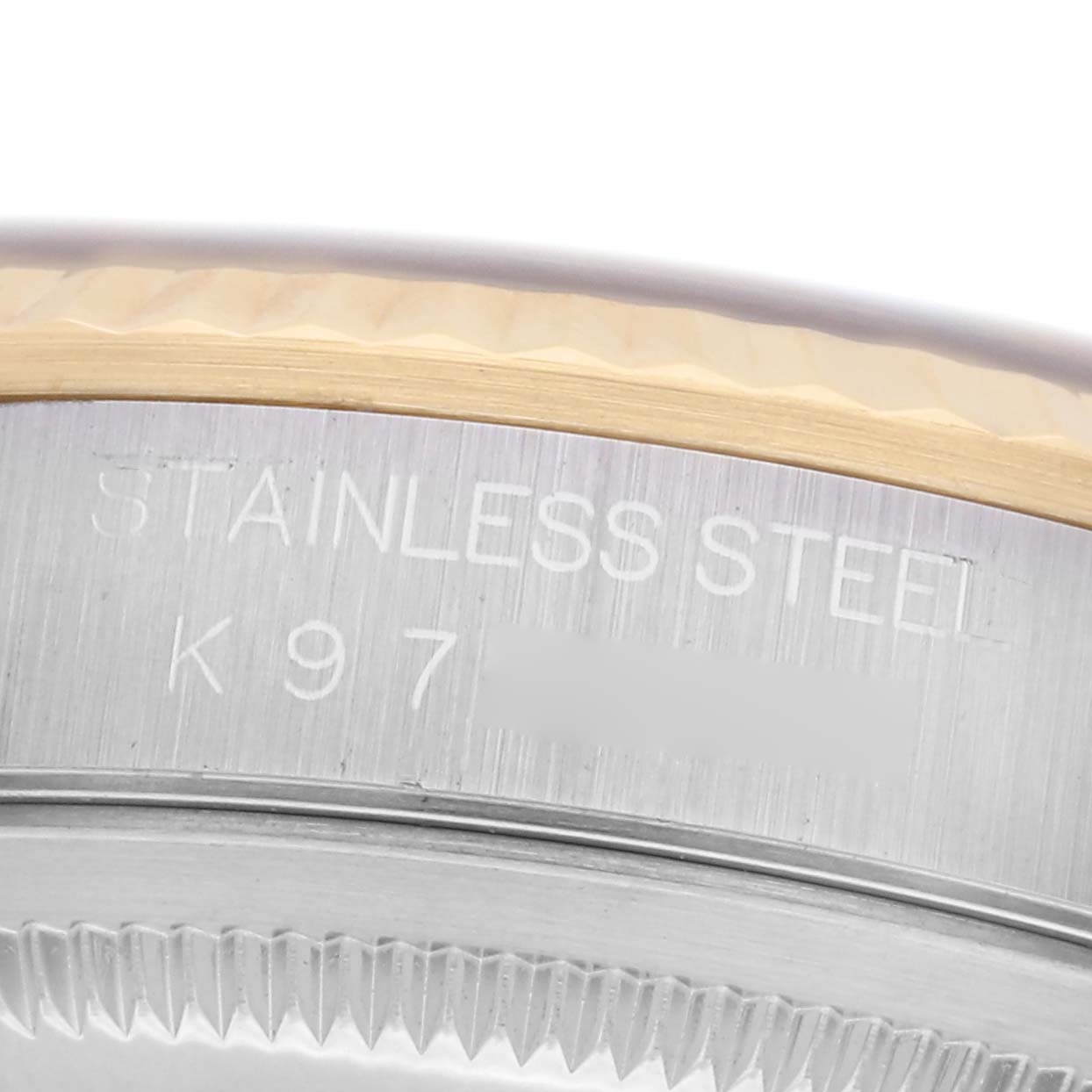 The image shows a close-up of the case edge and bezel of a Rolex Datejust 16233 Men
s Steel and Gold (two tone) Black Dial, highlighting the "STAINLESS STEEL" engraving.