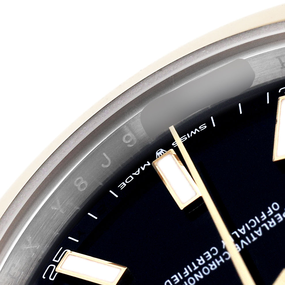 The image shows a close-up of the Rolex Datejust 126303 Men's Steel and Gold (two tone) Black Dial watch dial and indices at an angled view.