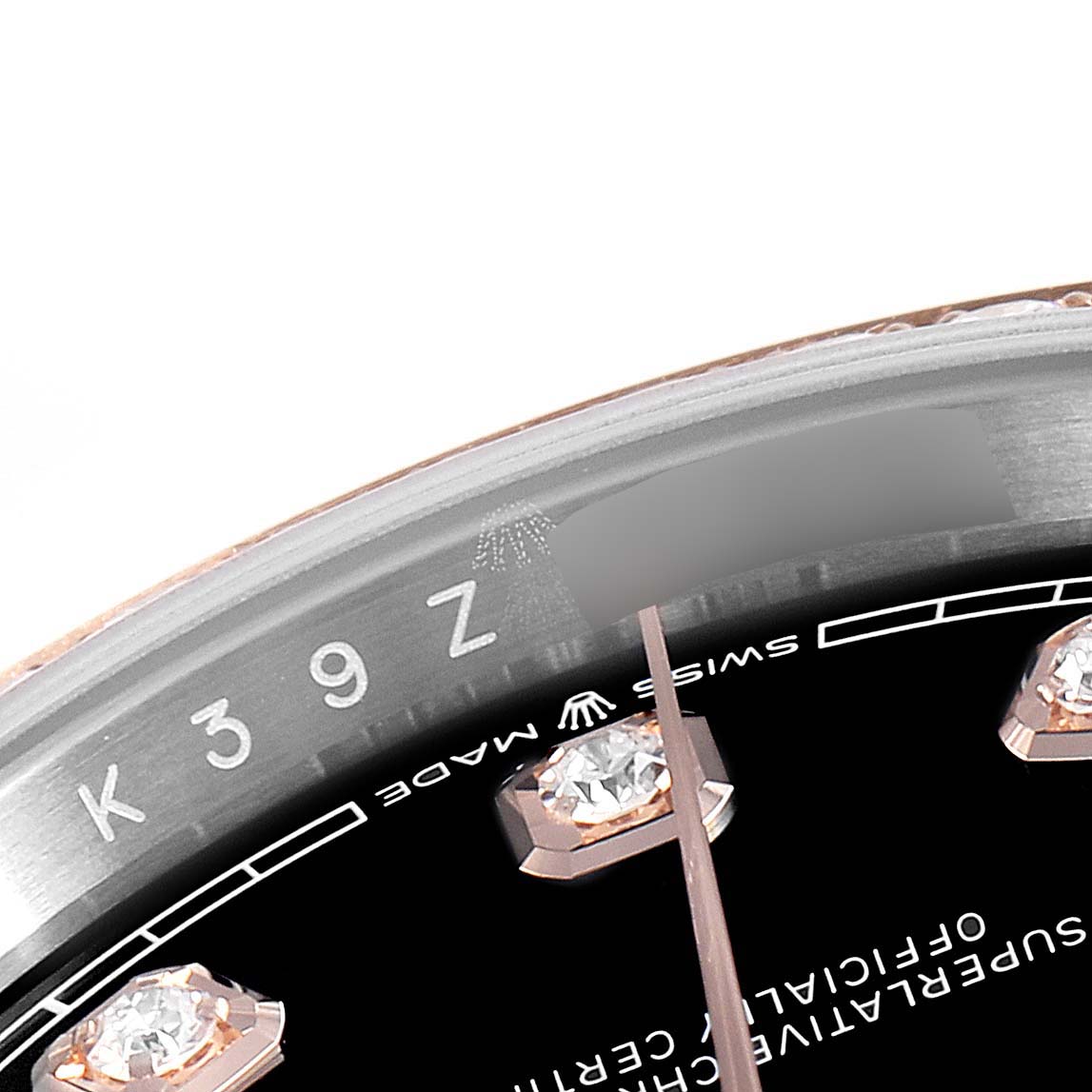 The image shows a close-up of the dial, diamonds markers, and the inner bezel with engravings on a Rolex Datejust 126281 Men's Rose Gold Black Dial 126281 Men's Rose Gold Black Dial model watch. 