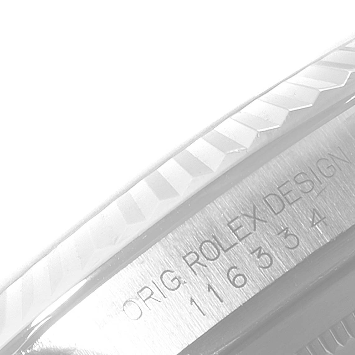 The image shows a close-up of the Rolex Datejust 41 116334 Men
s Stainless Steel Blue Dial
s case side, featuring the engravings and part of the fluted bezel.