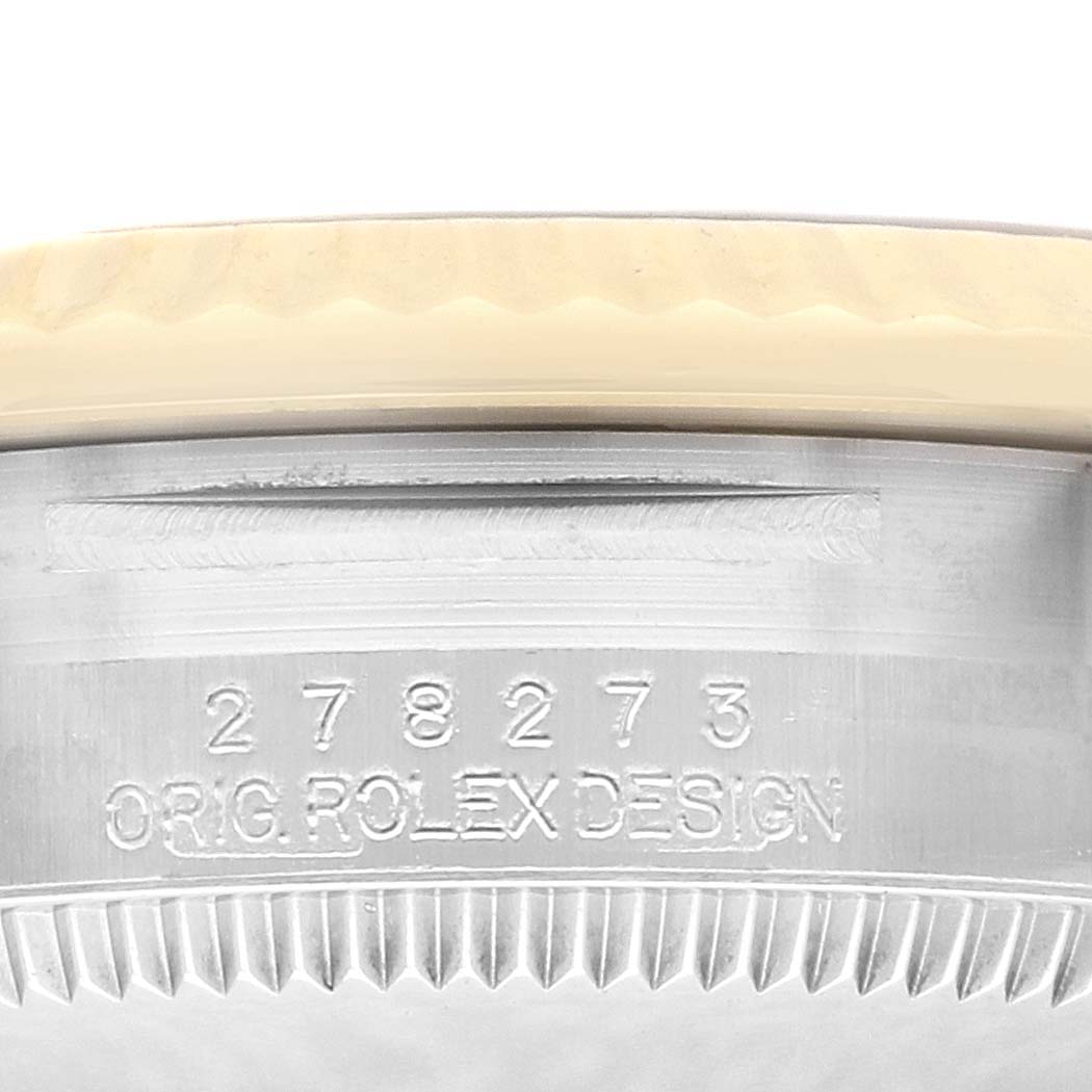 The image shows a close-up of the Rolex Datejust 278273 Men
s Stainless Steel Champagne Dial
s case, featuring the engraved model number and "ORIG. ROLEX DESIGN."