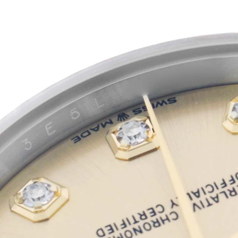 The image shows a close-up of a Rolex Datejust 278273 Men
s Stainless Steel Champagne Dial watch face, focusing on the diamonds, bezel, and text details.