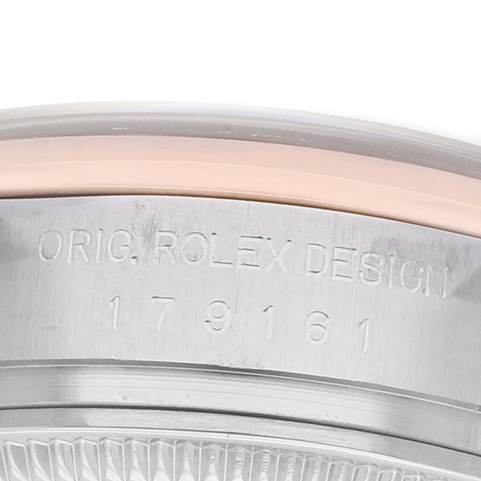 The image shows a close-up of the case side of a Rolex Datejust 179161 Women
s Steel and Gold (two tone) Black Dial, highlighting the "ORIG. ROLEX DESIGN" and model number engraving.